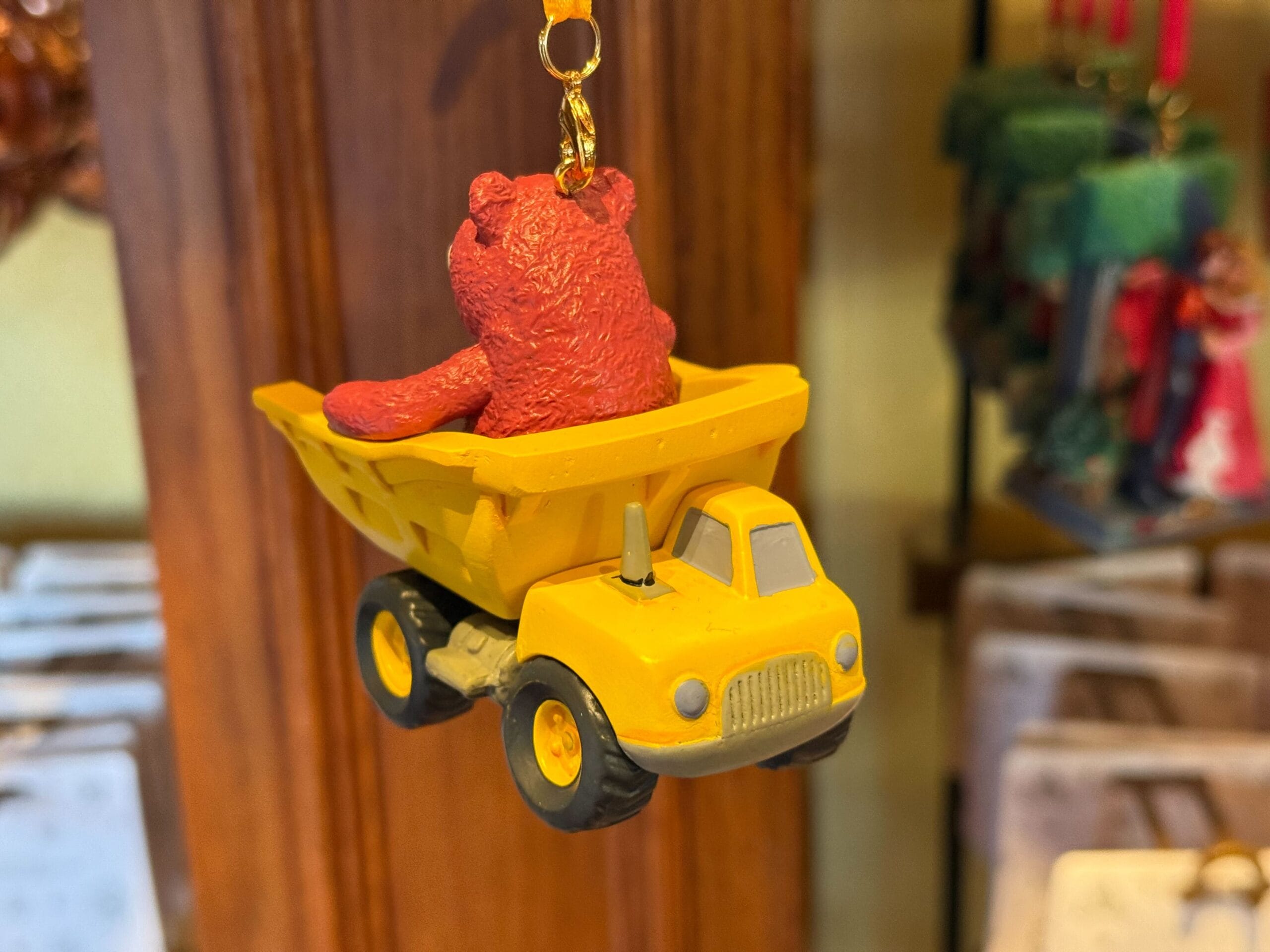 Back of Disney Sketchbook ornament of Lotso Huggin' Bear in a yellow dump truck with a lobster claw clasp.