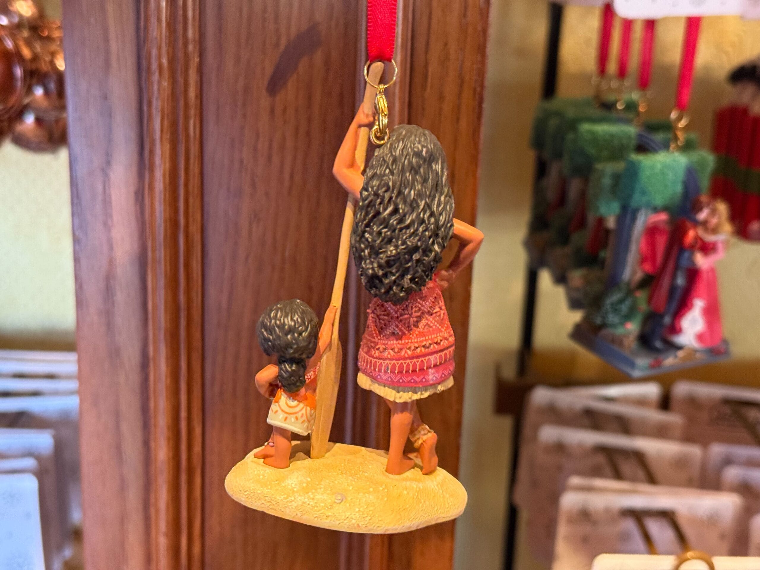 Back of Disney Sketchbook ornament of Moana and her little sister Simea leaning on either sides of an oar.