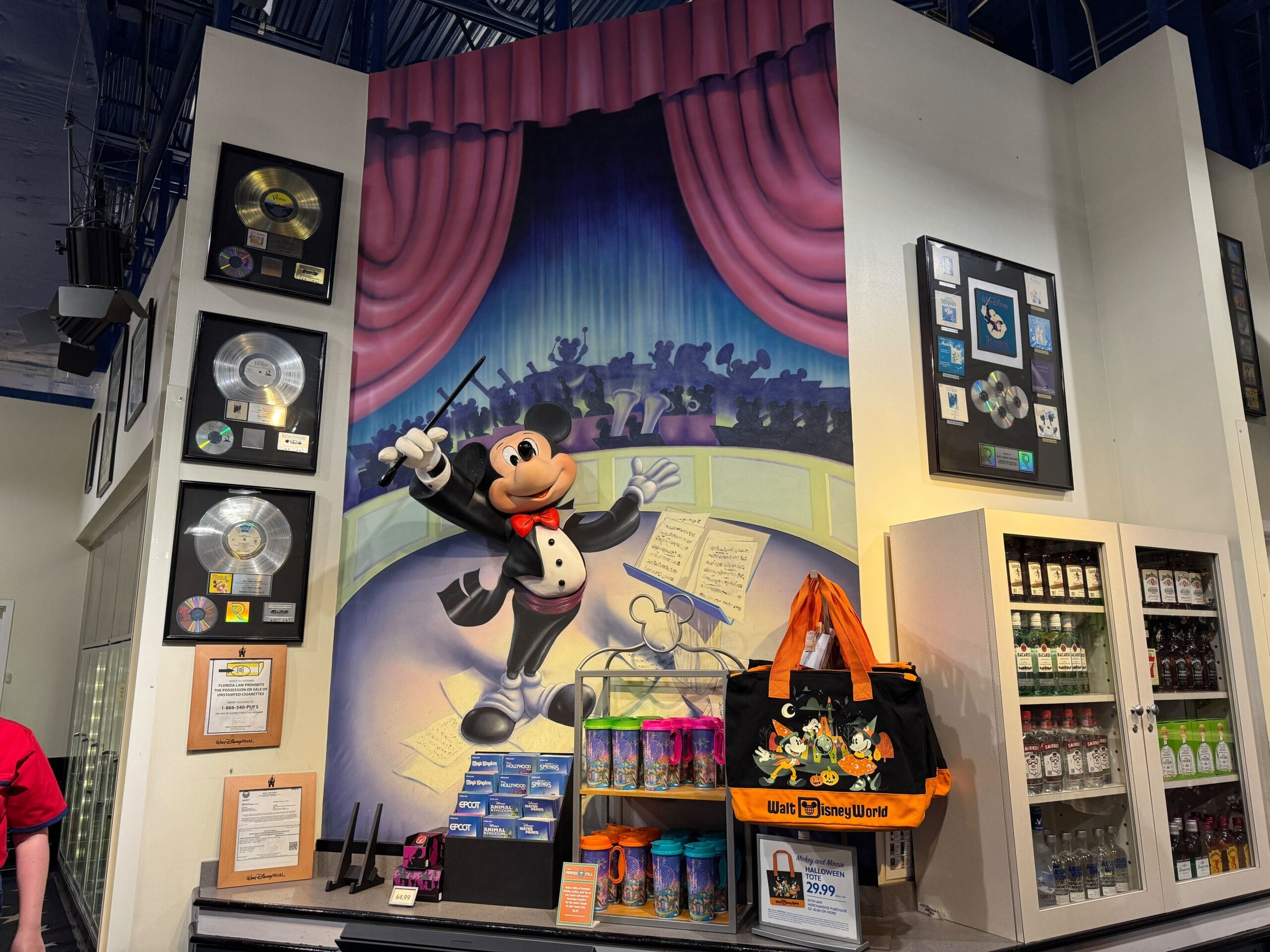 A mural of Maestro Mickey’s as a conductor, with Disney merchandise and framed records, brightens this music resort store.