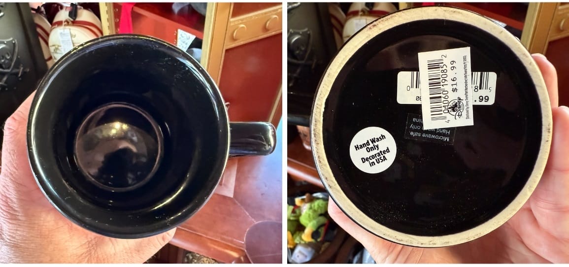 A hand holds up a barrel-inspired mug to show the solid black interior and bottom.