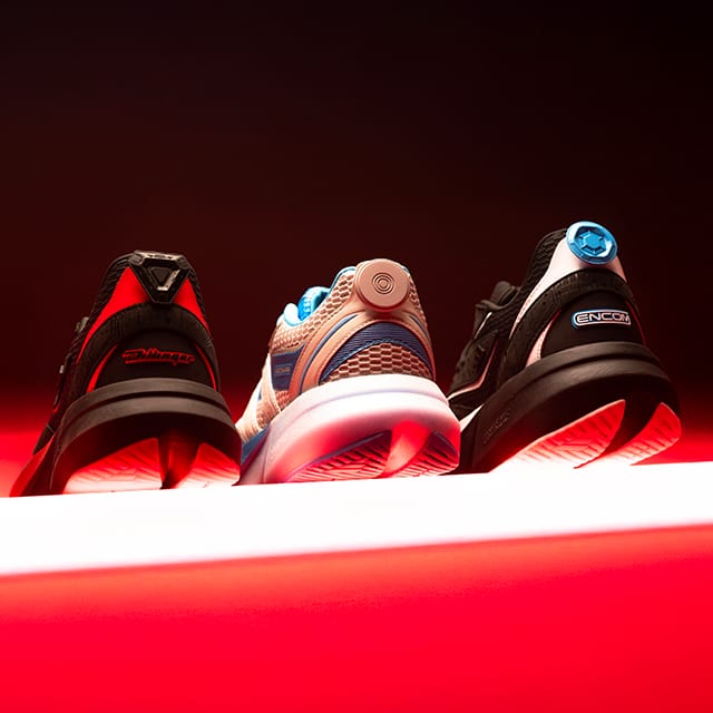 Three different Adidas TRON: Ares Lightblaze sneakers, showing the replica Identity Disc charms on the back.