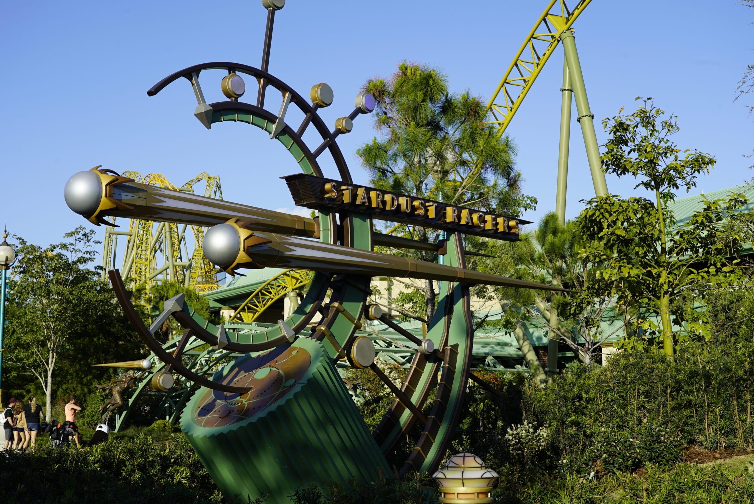 Futuristic “Stardust Racers” ride sign with green tracks at Universal's lush, green-themed park.