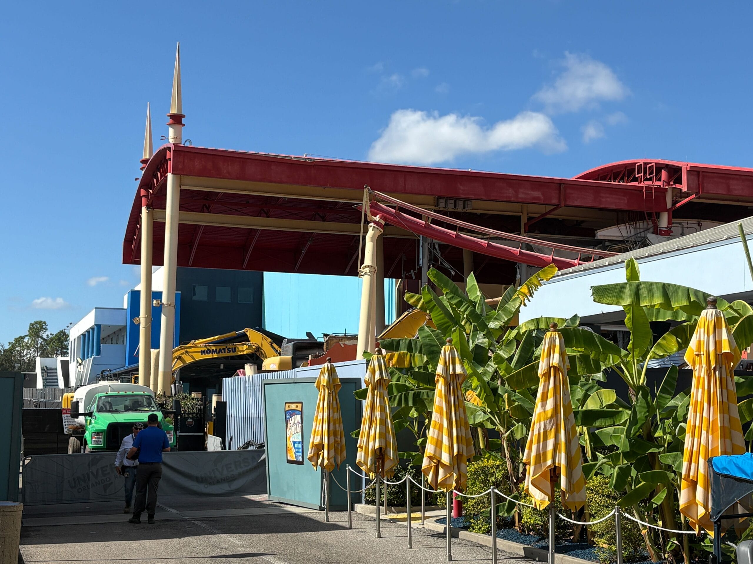 Yellow-striped umbrellas and construction vehicles work on track removal near Rip Ride Rockit at Universal Studios.