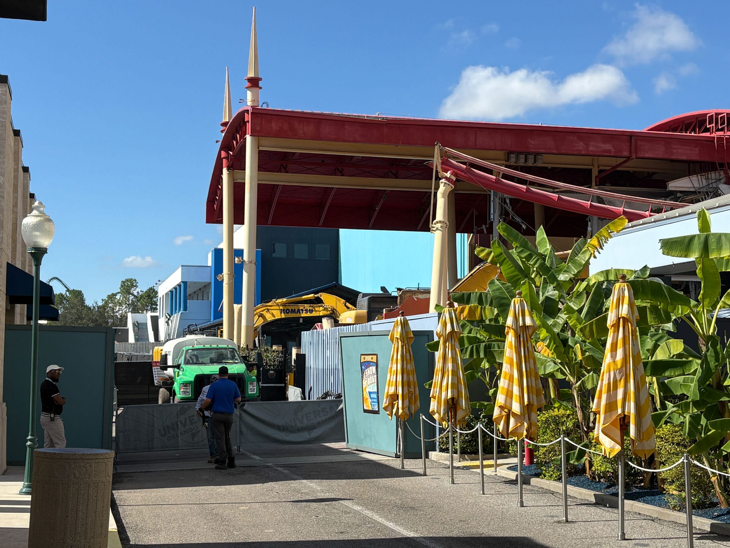Construction site with yellow equipment and workers where the Rip Ride Rockit track was removed, under blue skies.