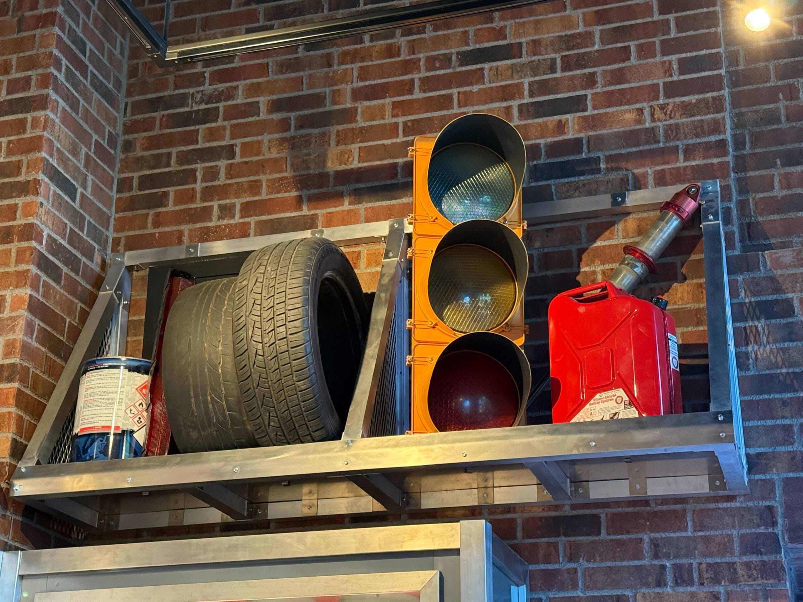 A shelf with Fast & Furious merchandise—tire, traffic light, gas can, and more—at Universal Studios Hollywood.