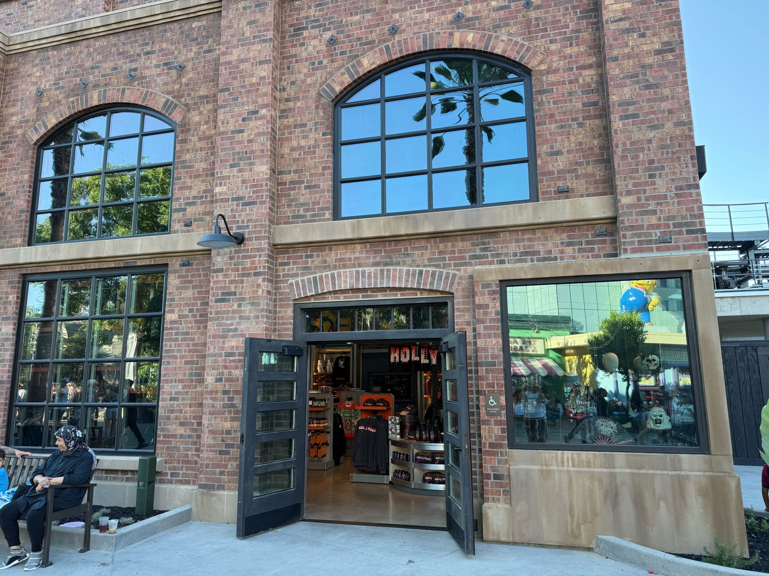 A brick building with large windows houses the Fast & Furious Store at Universal Studios Hollywood, decorated for Halloween.