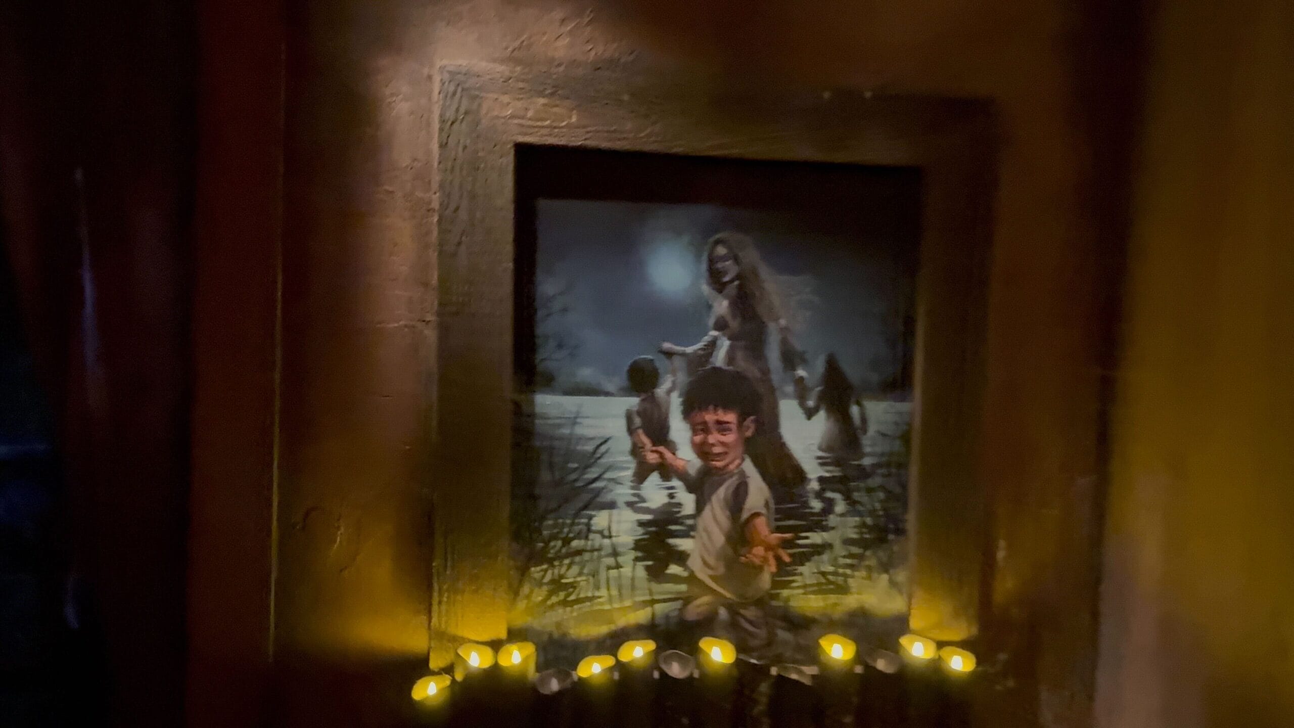 A painting of children and a woman in a pond, illuminated by dim lights and candles—evoking Monstros 3 at USH.