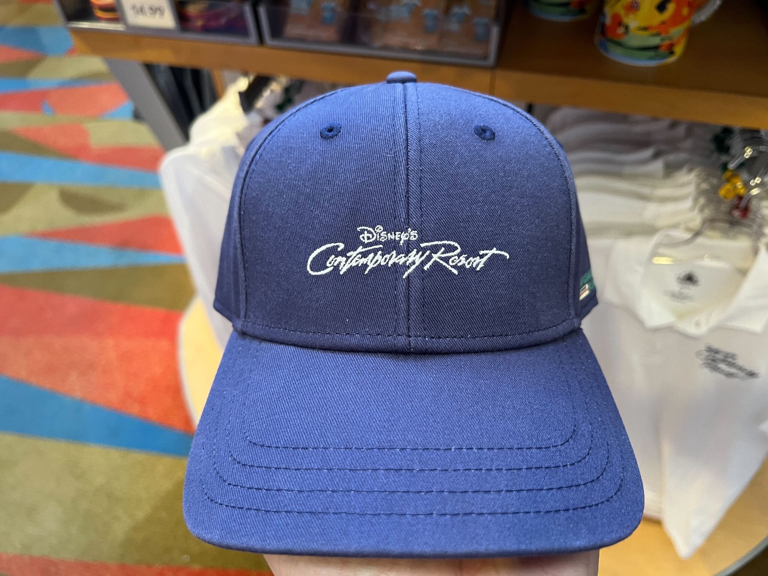 A blue baseball cap from the Monorail Collection with "Disney's Contemporary Resort" embroidered in white on the front.