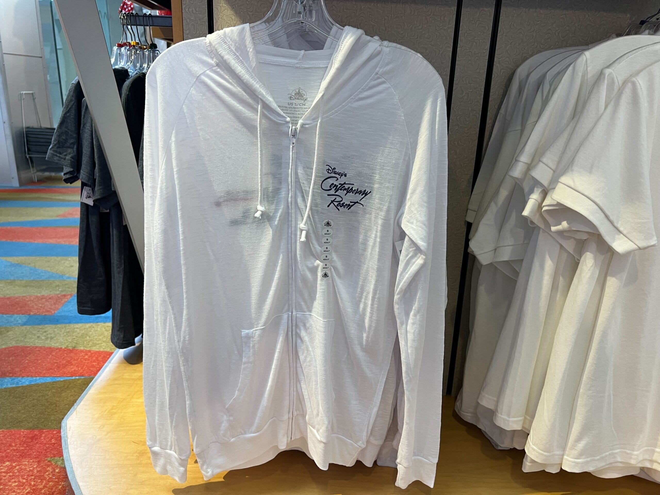 A white zip-up hoodie from the Monorail Collection, featuring "Disney's Contemporary Resort" embroidered on the chest.