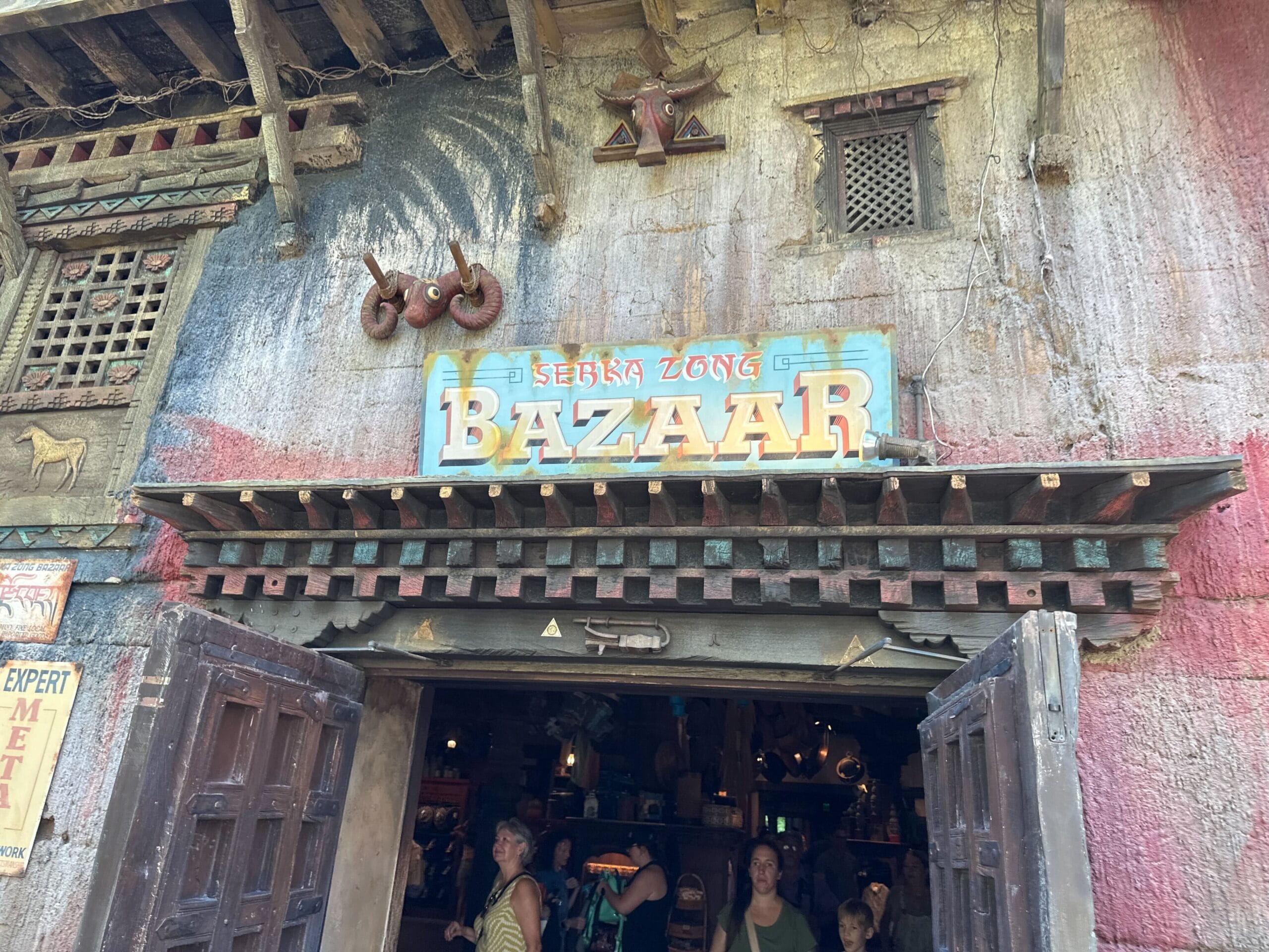 Entrance to Serka Zong Bazaar with rustic decor, open doors, and people entering the shop.