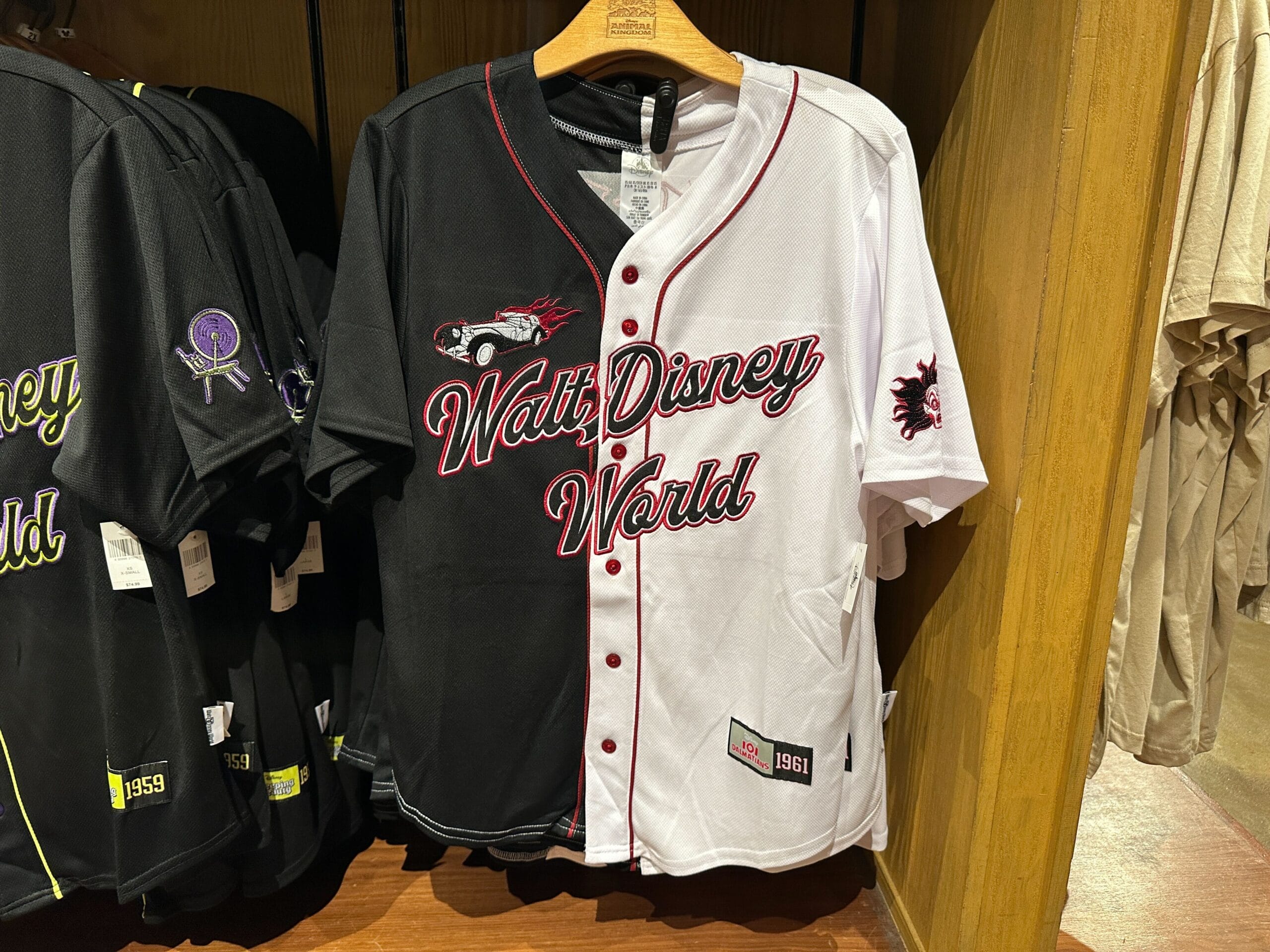 Cruella de Vil Baseball Jersey split black and white, reads "Walt Disney World", with car and dragon patch—perfect for Animal Kingdom fans.