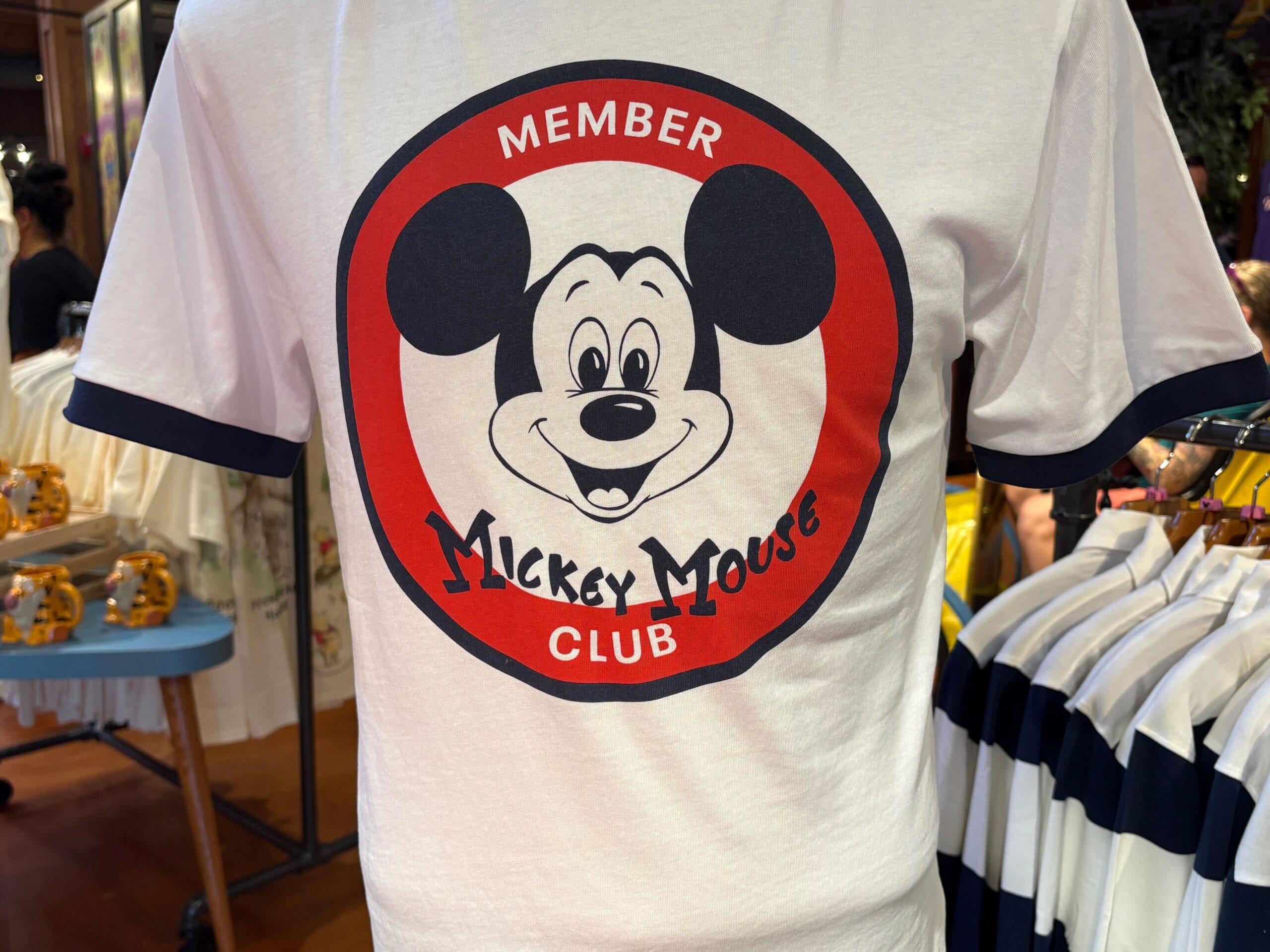 White T-shirt with "Member Mickey Mouse Club" and a large Mickey face inside a red circle—part of the 70th Collection.