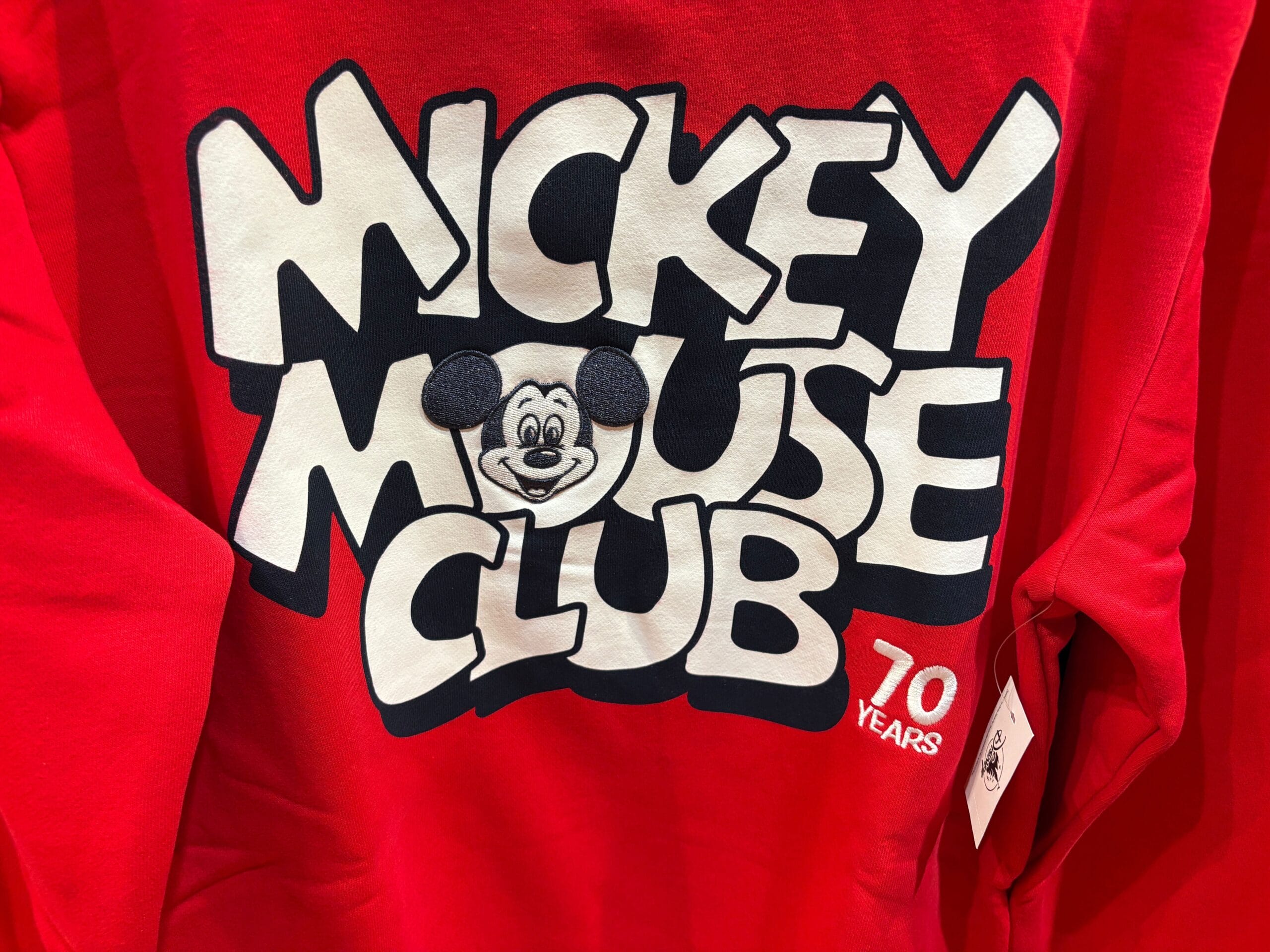 Red shirt from the 70th Collection featuring "Mickey Mouse Club," Mickey's face, and "70 Years" on the front.