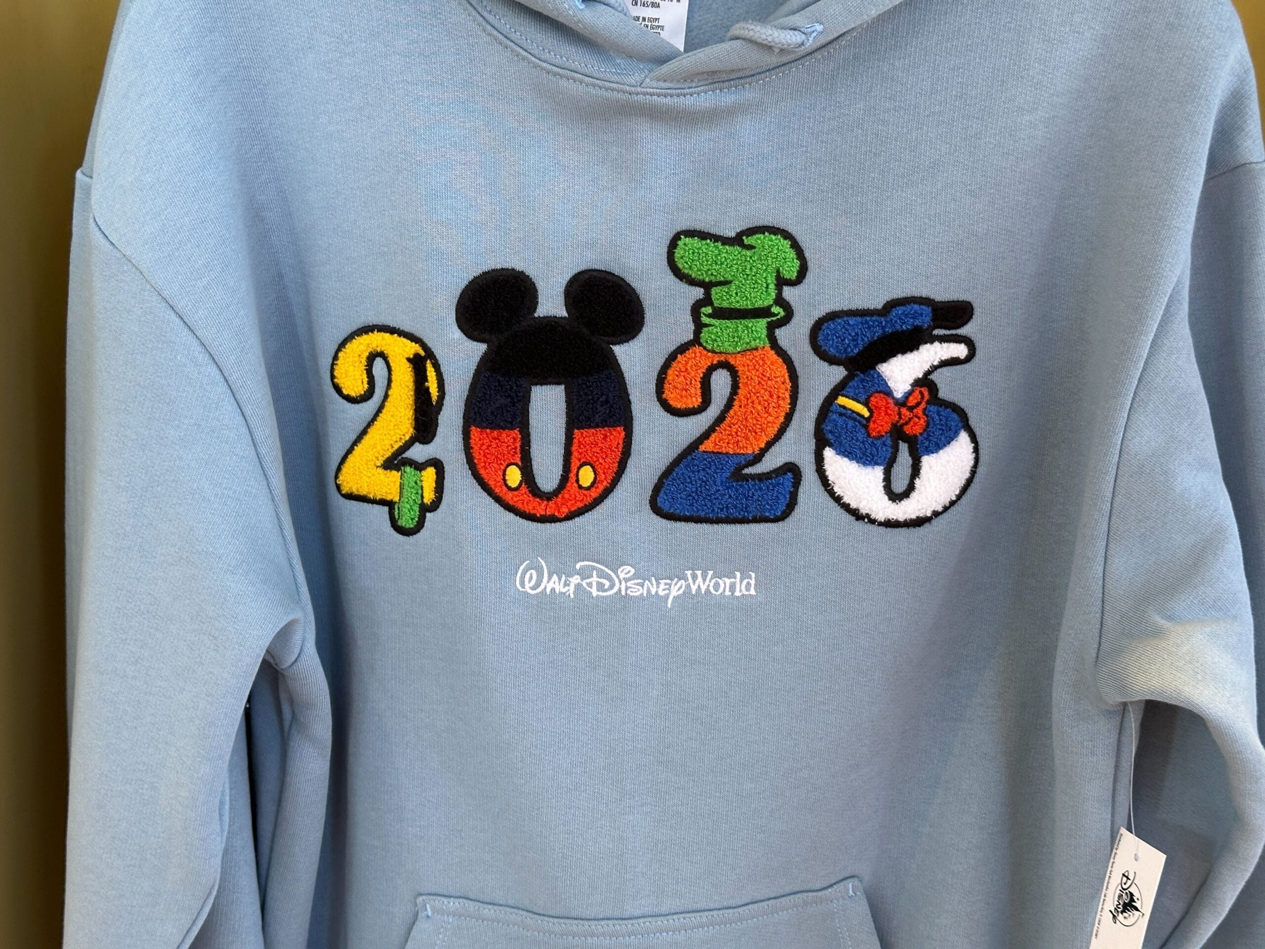 A blue Hooded Sweatshirt with "2023" as Disney characters and "Walt Disney World" printed below.