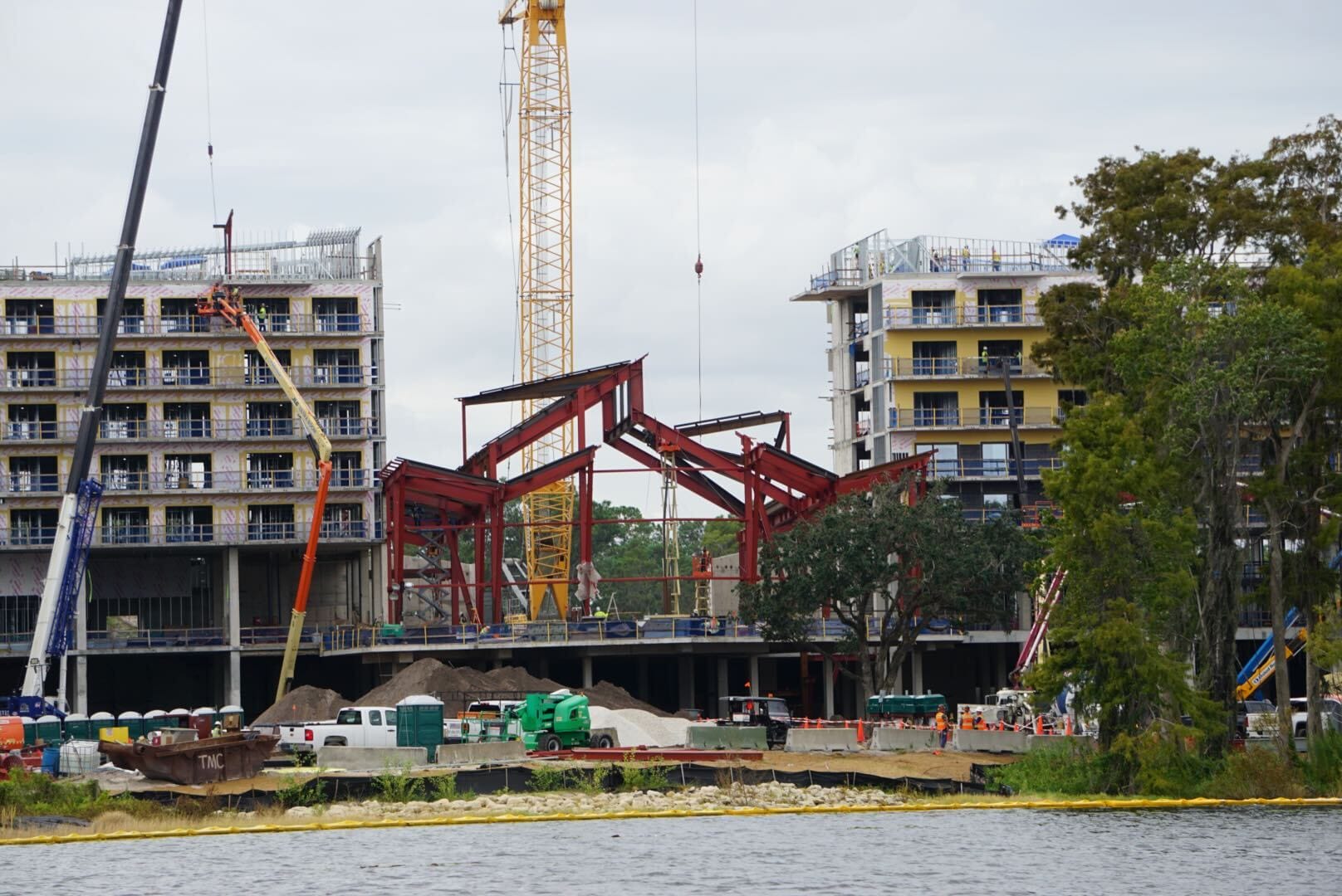 Lakeshore Update: Construction site with cranes, steel framework, and rising multi-story buildings by the water.