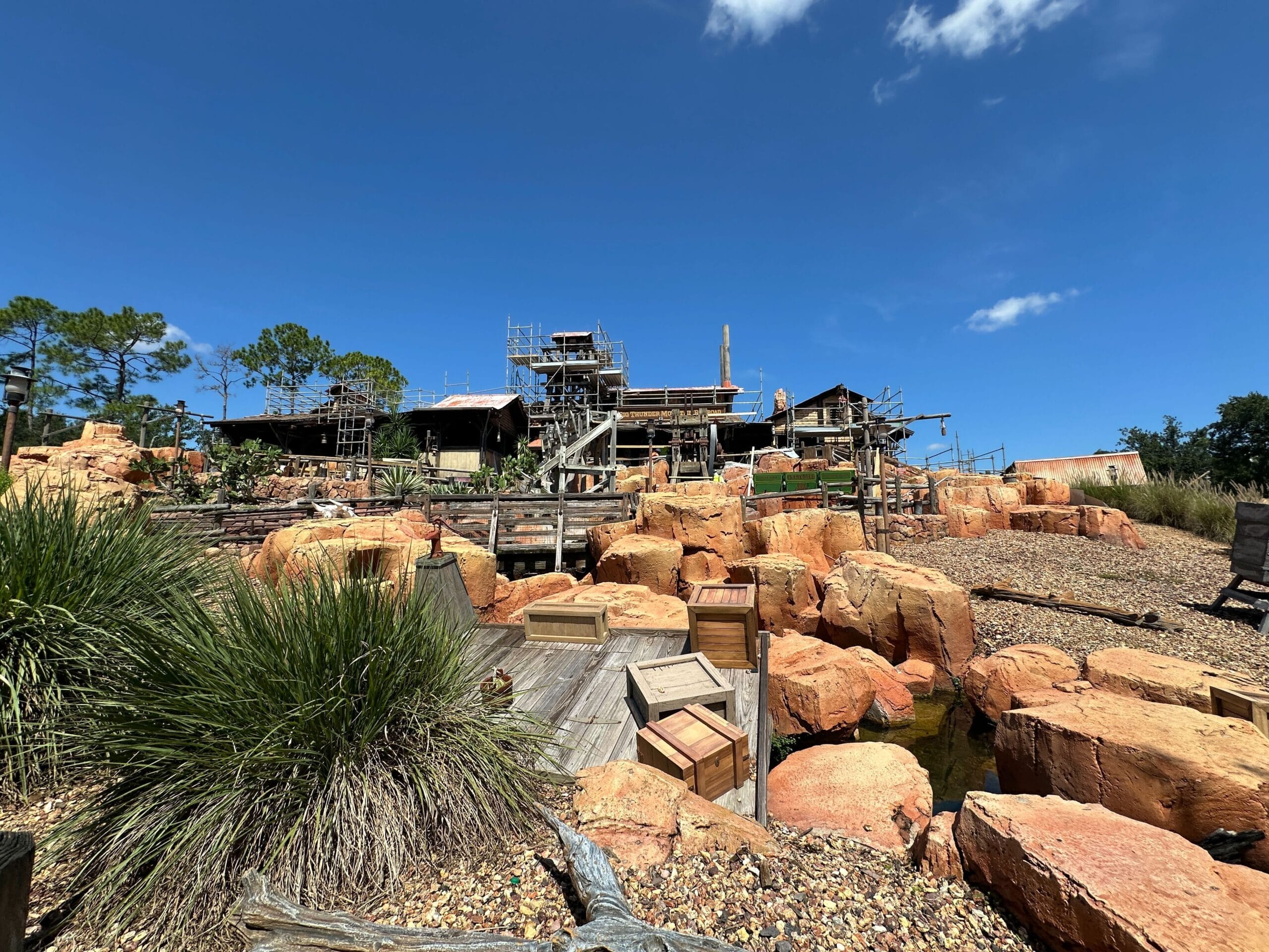 Old wooden structures and orange rocks hint at Rockwork Progress in the Big Thunder Mountain Refurbishment.