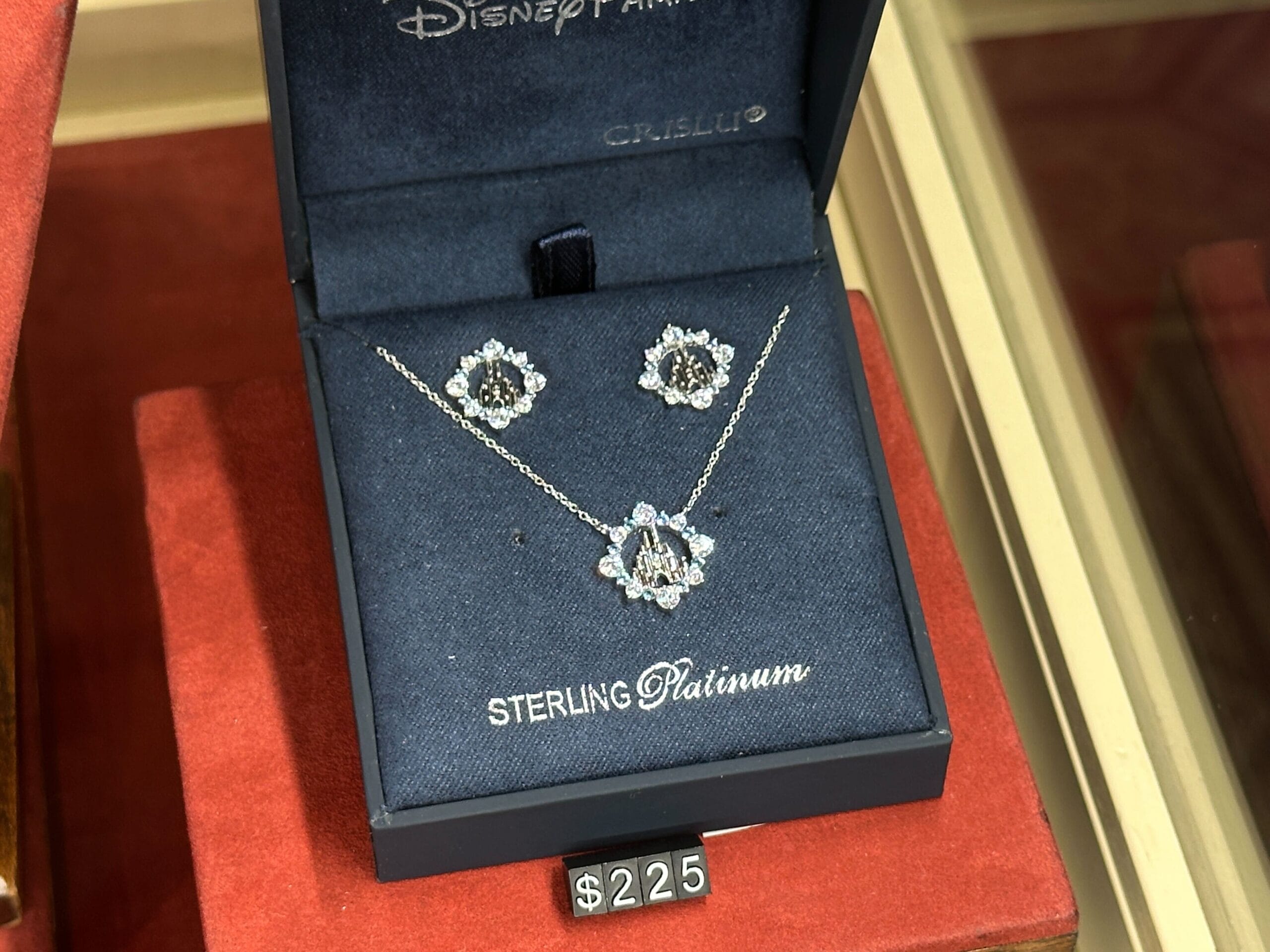 A fine jewelry sterling platinum necklace and earring set in a blue box, priced at $225.