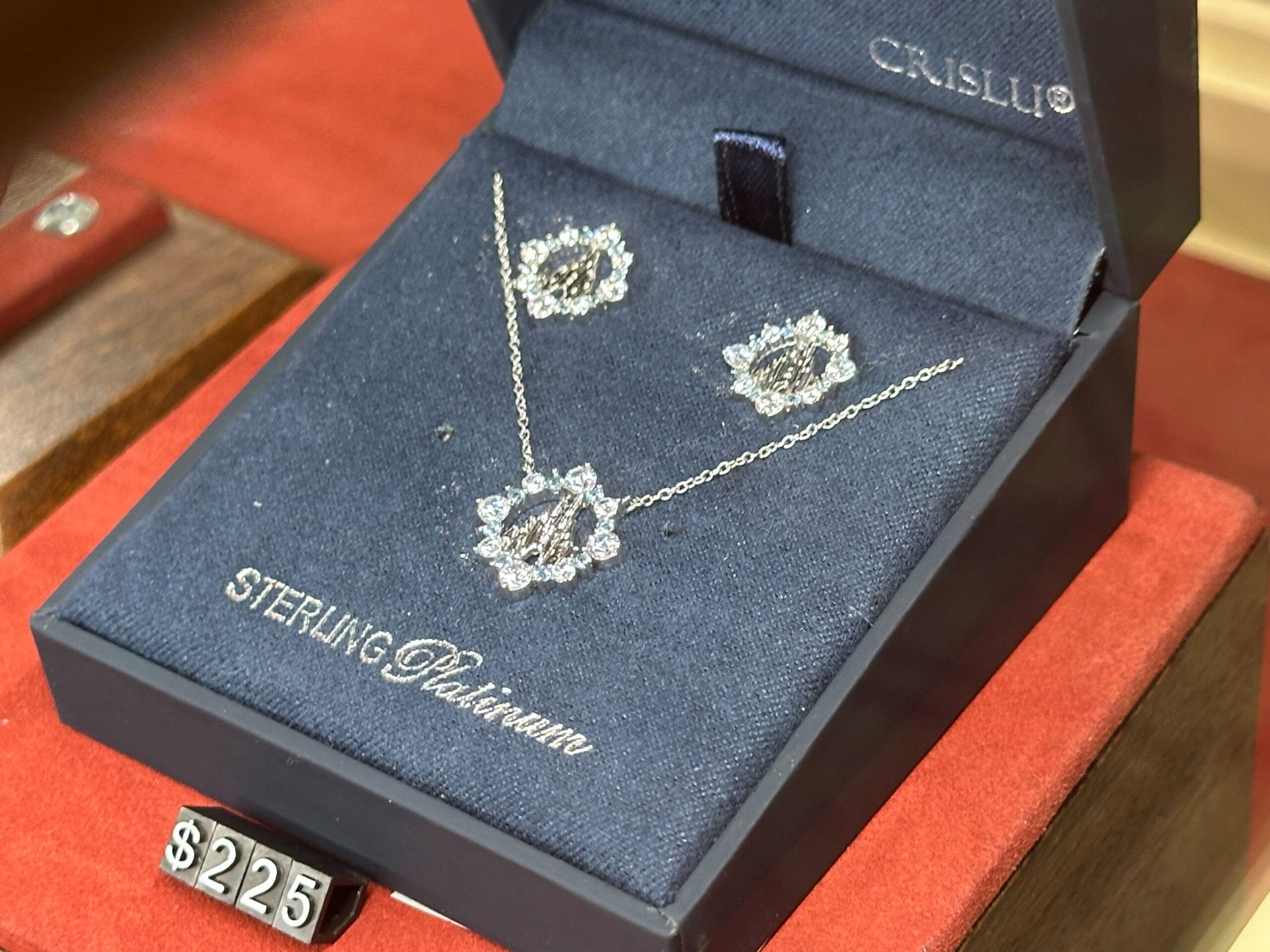 Fine Jewelry sterling platinum necklace and earrings set in a navy blue CRISLU box, inspired by Disney World, $225.