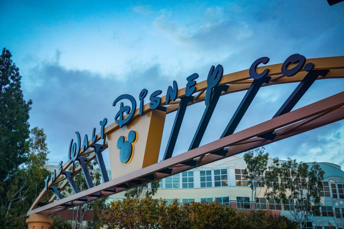 An archway with “The Walt Disney Co.” and a Mickey Mouse symbol