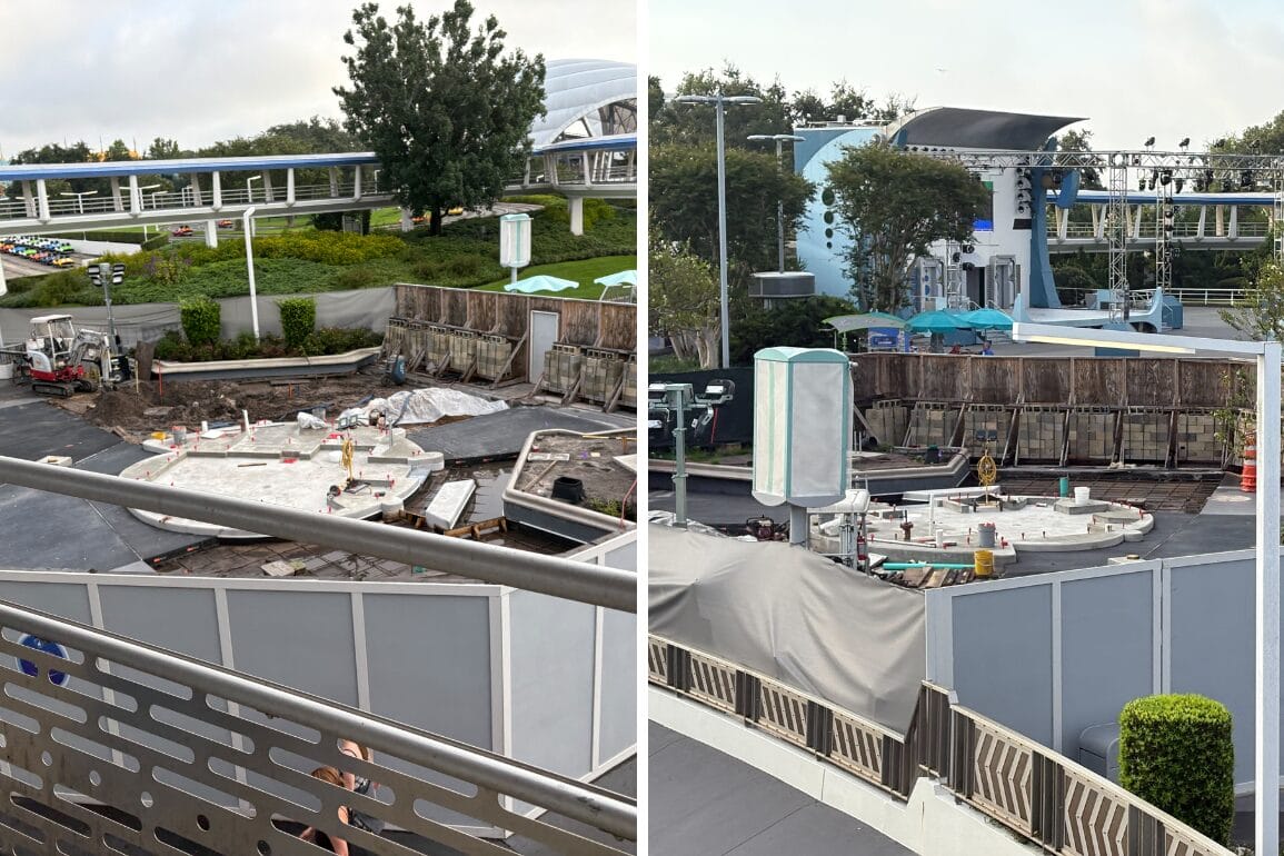 Construction site with machinery and barriers, viewed from above, near walkways and trees, buildings in the background.