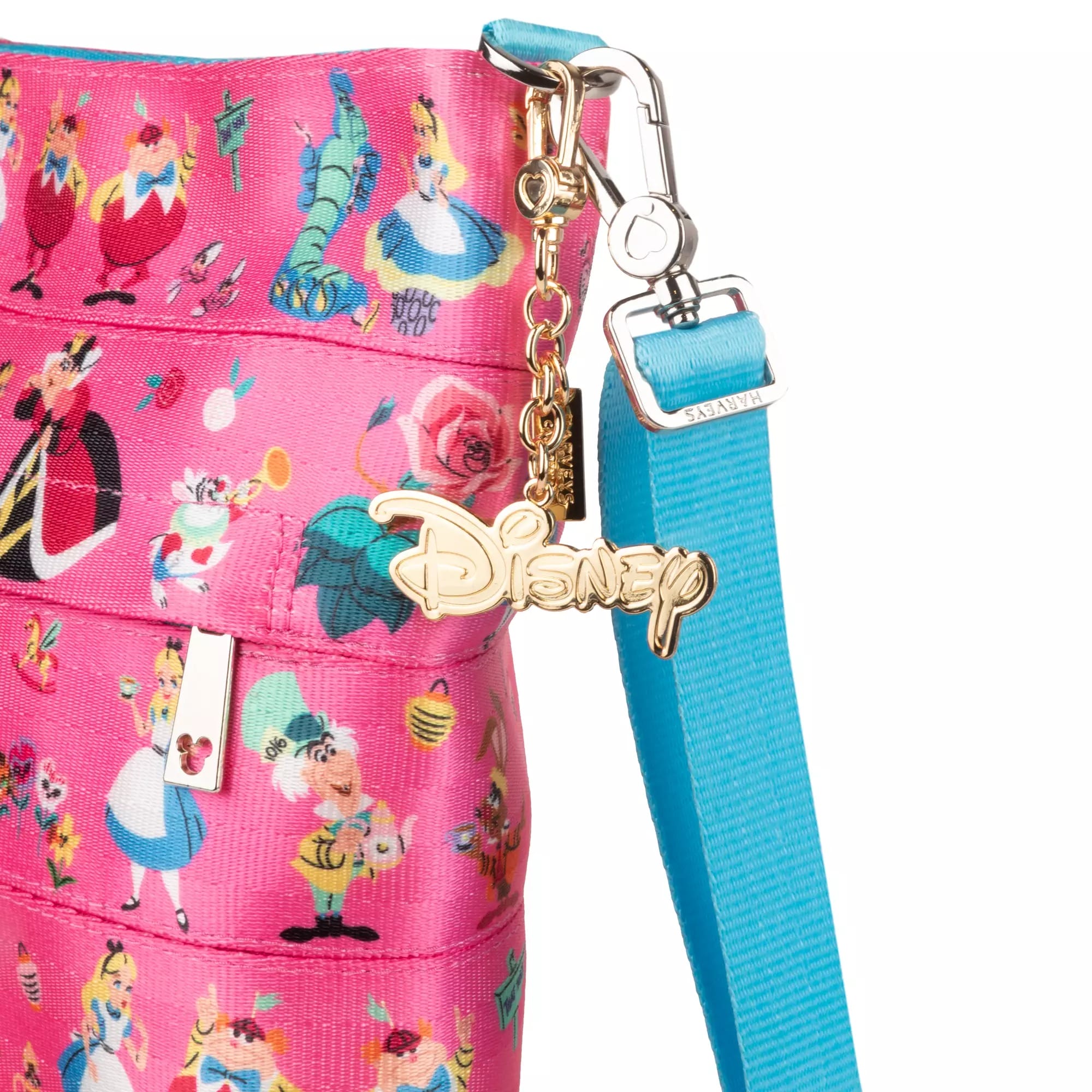 Close-up of a Disney Store pink Harveys Alice in Wonderland bag with characters and a gold Disney logo charm.