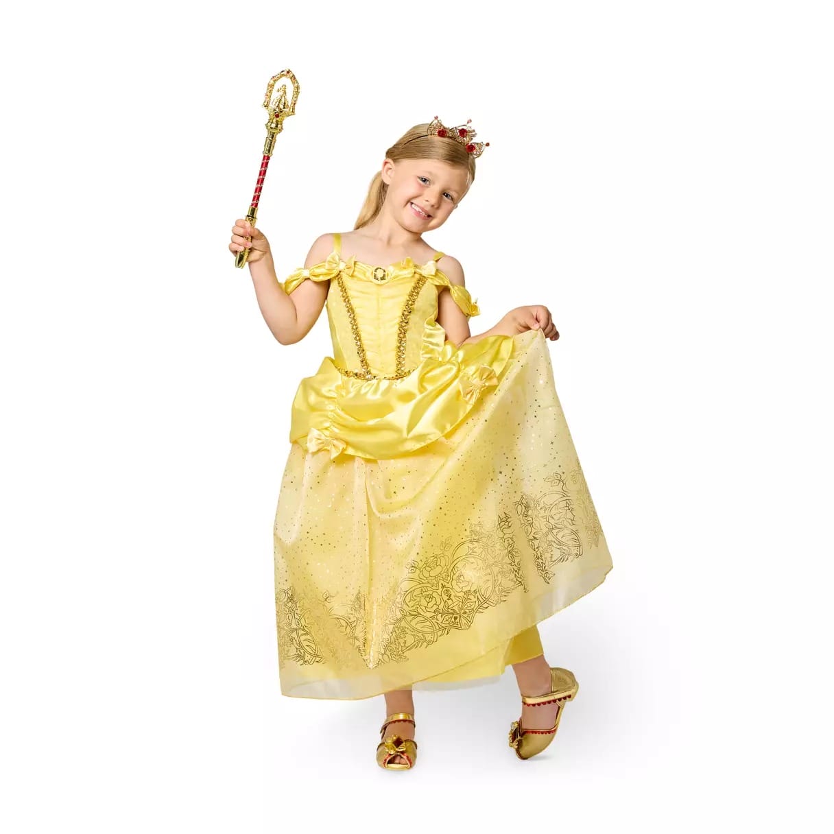 Young child in a Disney Store princess dress and crown, holding a wand and smiling, posing against a white background.