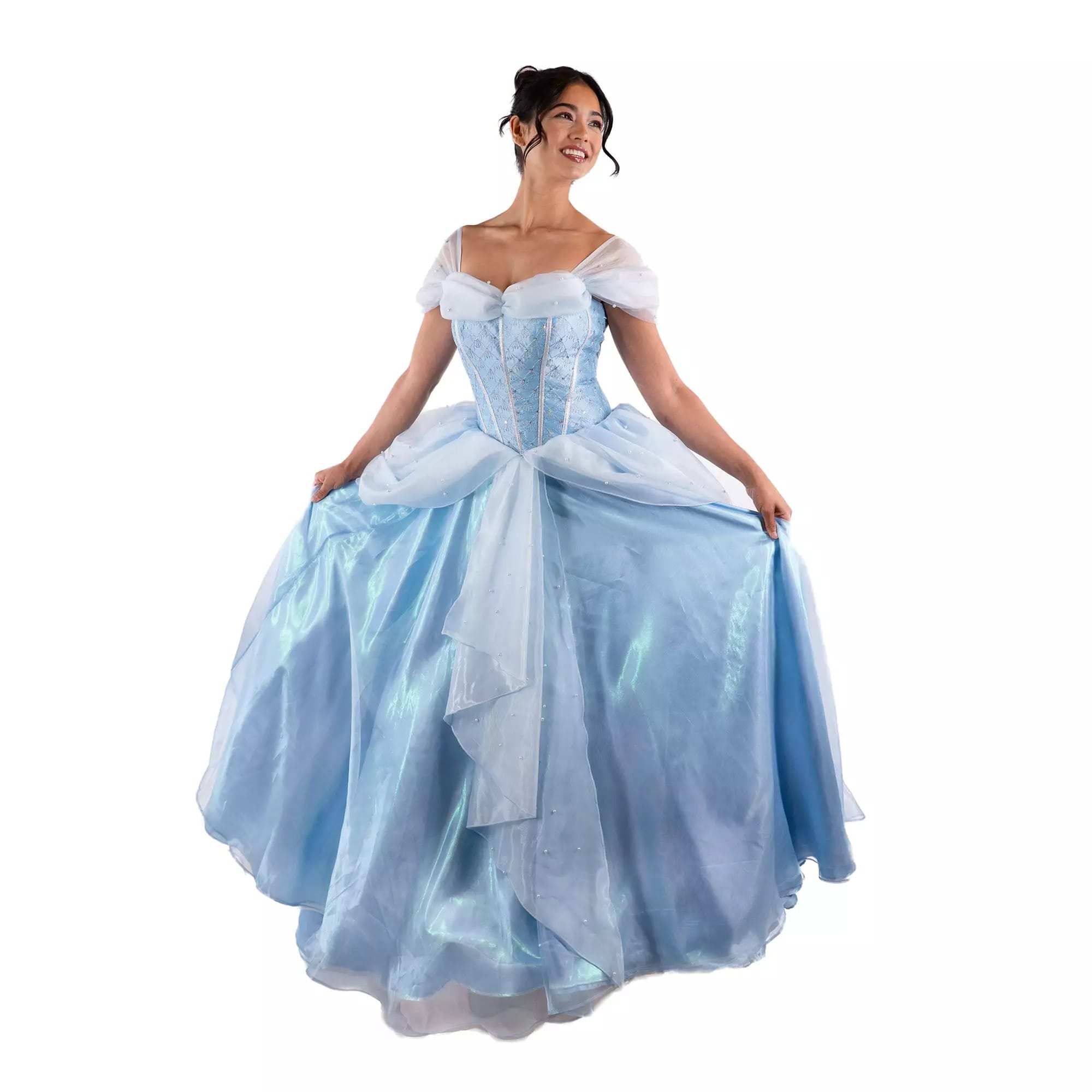 Woman in a light blue, off-shoulder princess gown from the Disney Store smiling and holding out her dress.