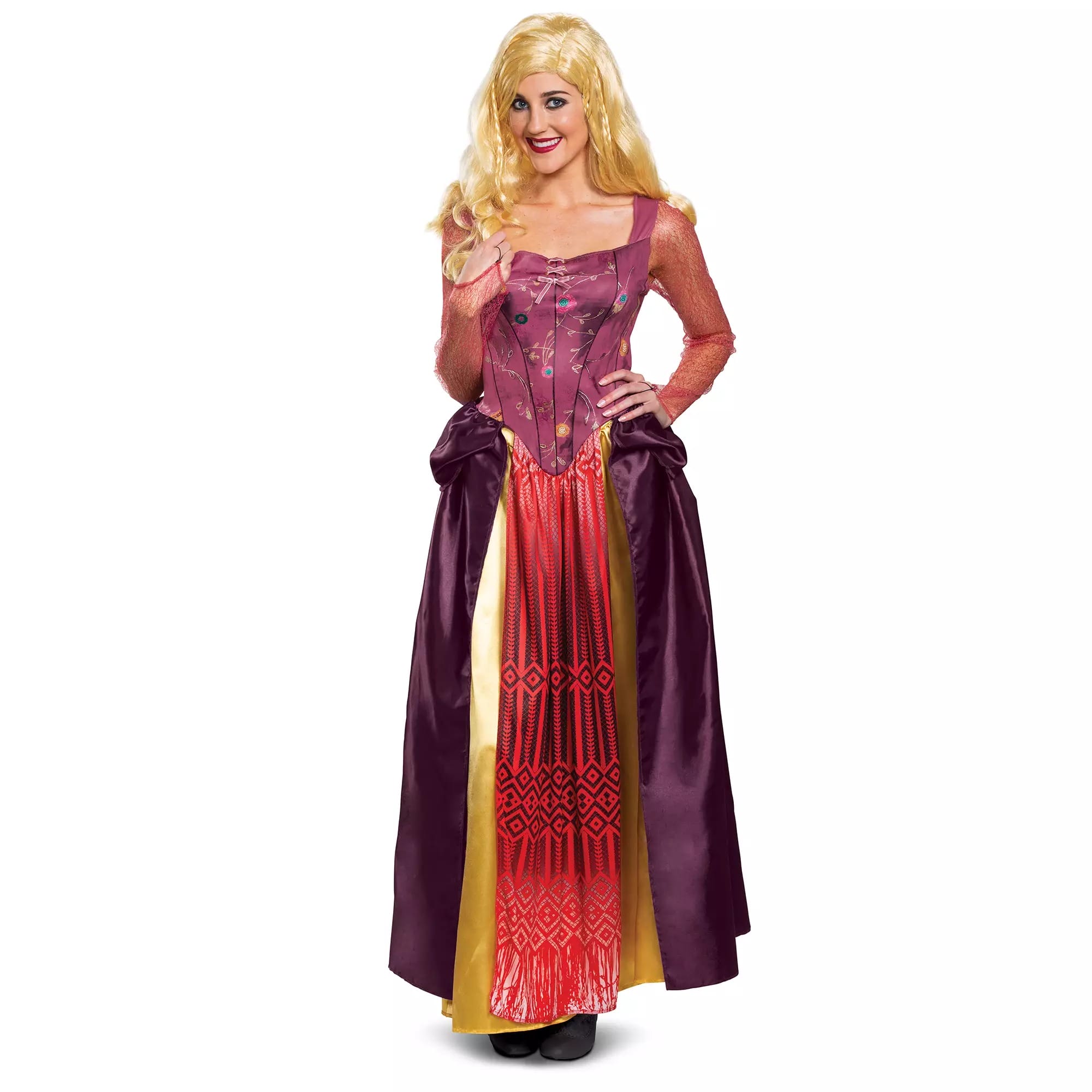Woman in a long, colorful princess dress from the Disney Store, smiling and posing with one hand near her face.