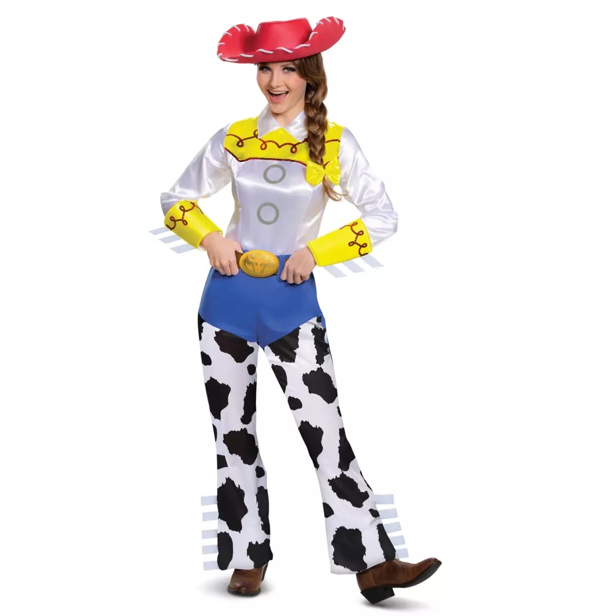 Person in a Disney Store Toy Story Jessie Halloween costume with cow-print pants, yellow accents, red hat, and brown boots, smiling.