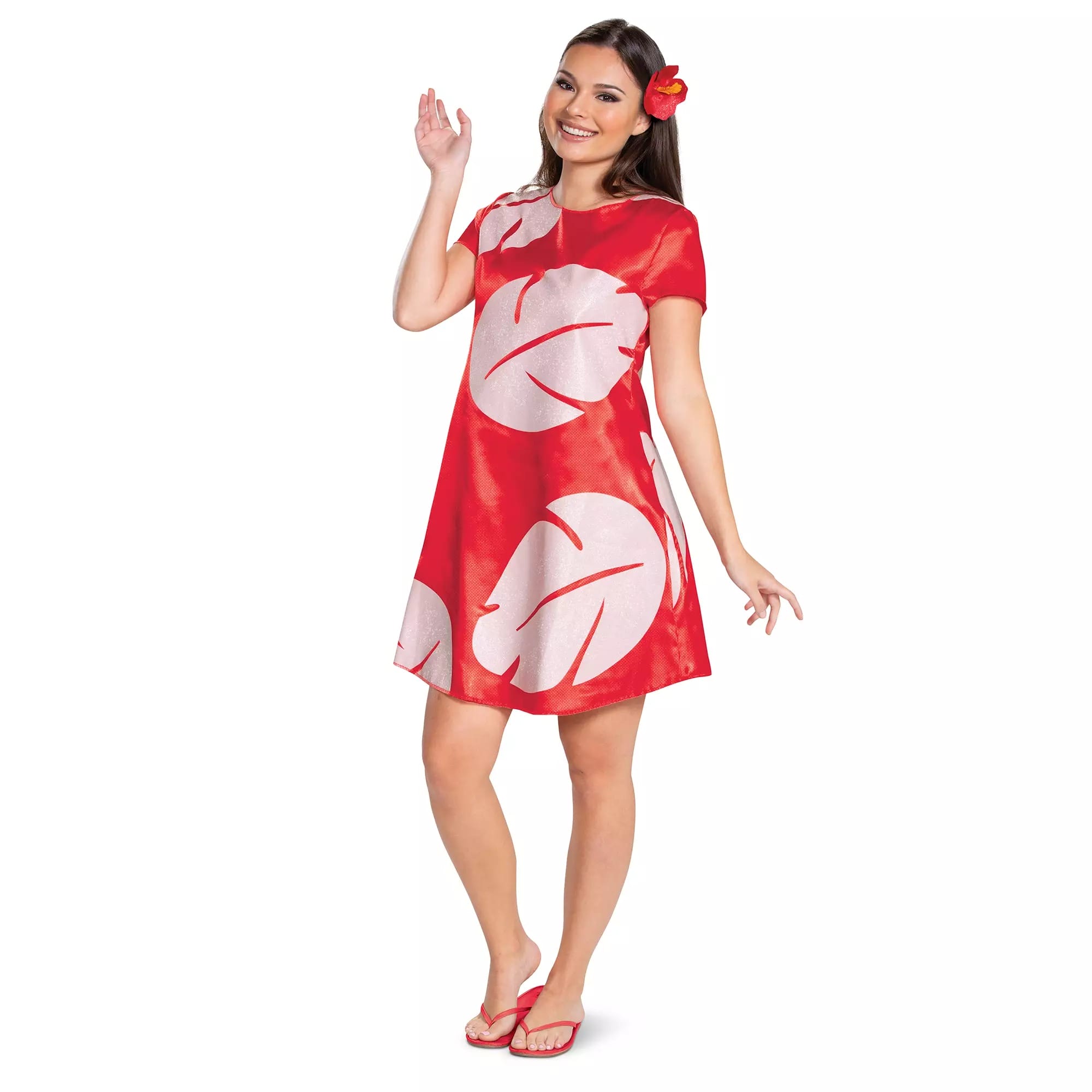 Smiling woman in a red dress with white leaf prints, like styles from the Disney Store, red flip-flops, and a red flower.