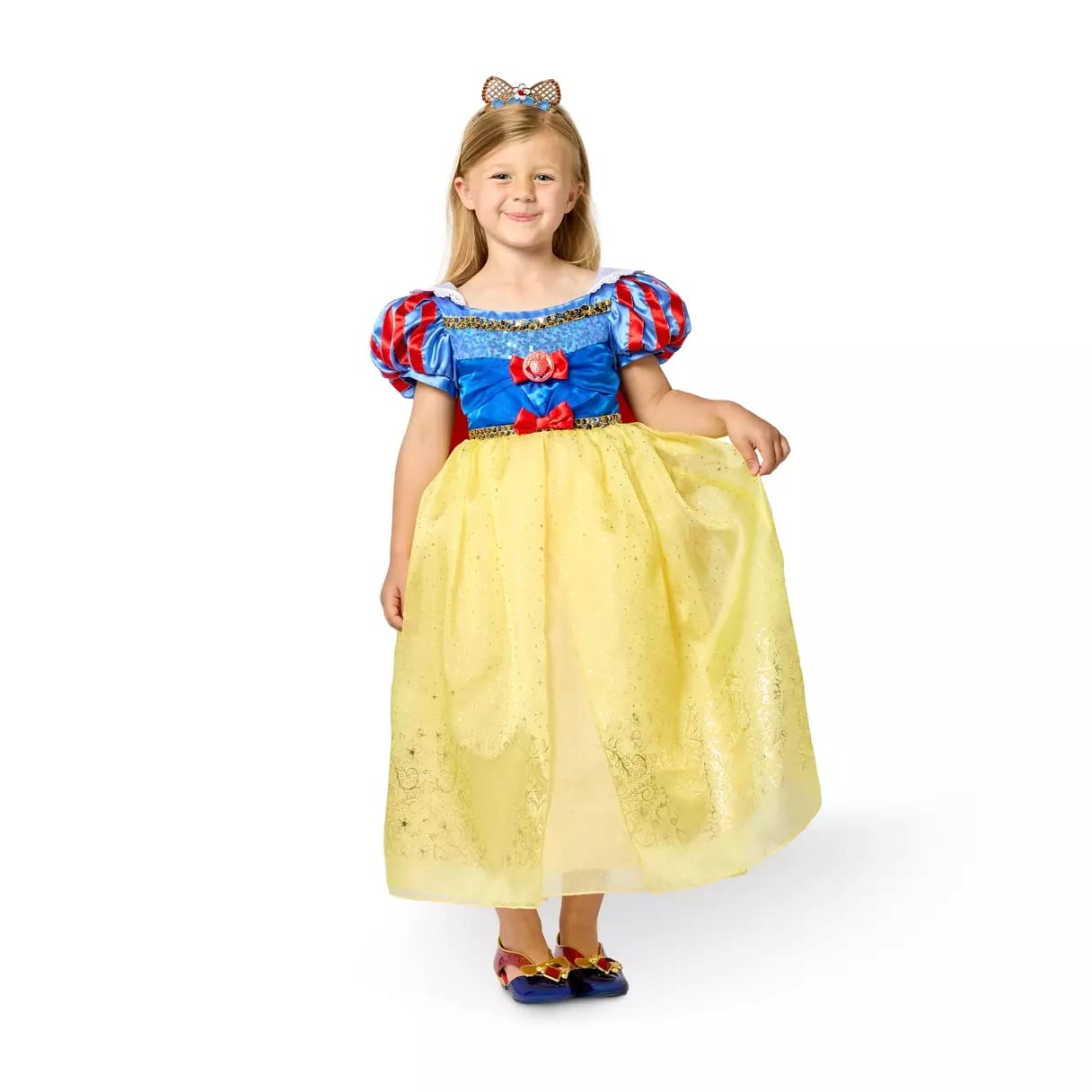 Young girl smiling in a Disney Store Snow White costume dress with a blue top, yellow skirt, and bow headband.
