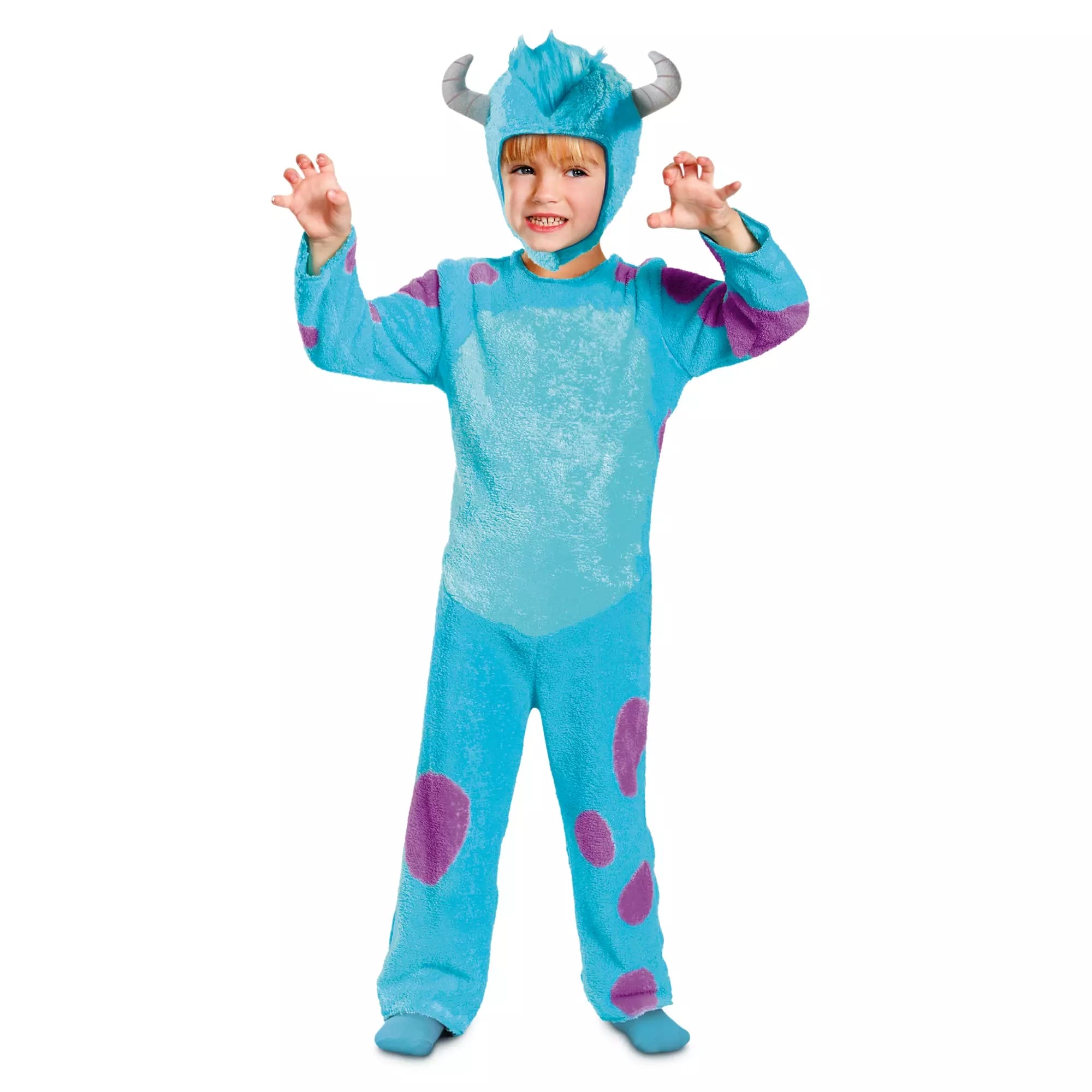 Child in a blue monster Halloween costume with purple spots and horns poses playfully against a white background.