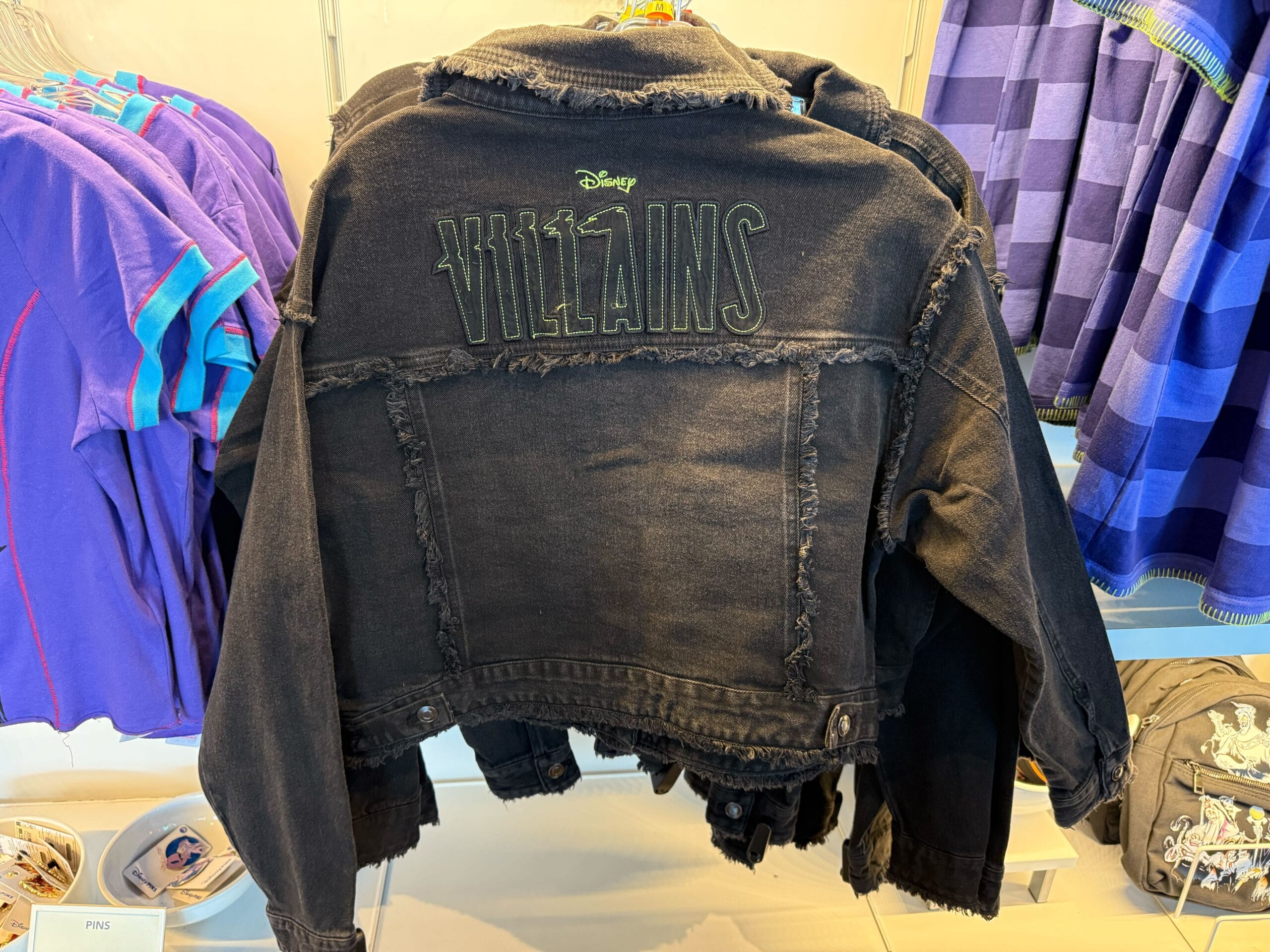 Black denim jacket with "Disney Villains" embroidery—perfect Halloween merchandise for Disneyland fans.
