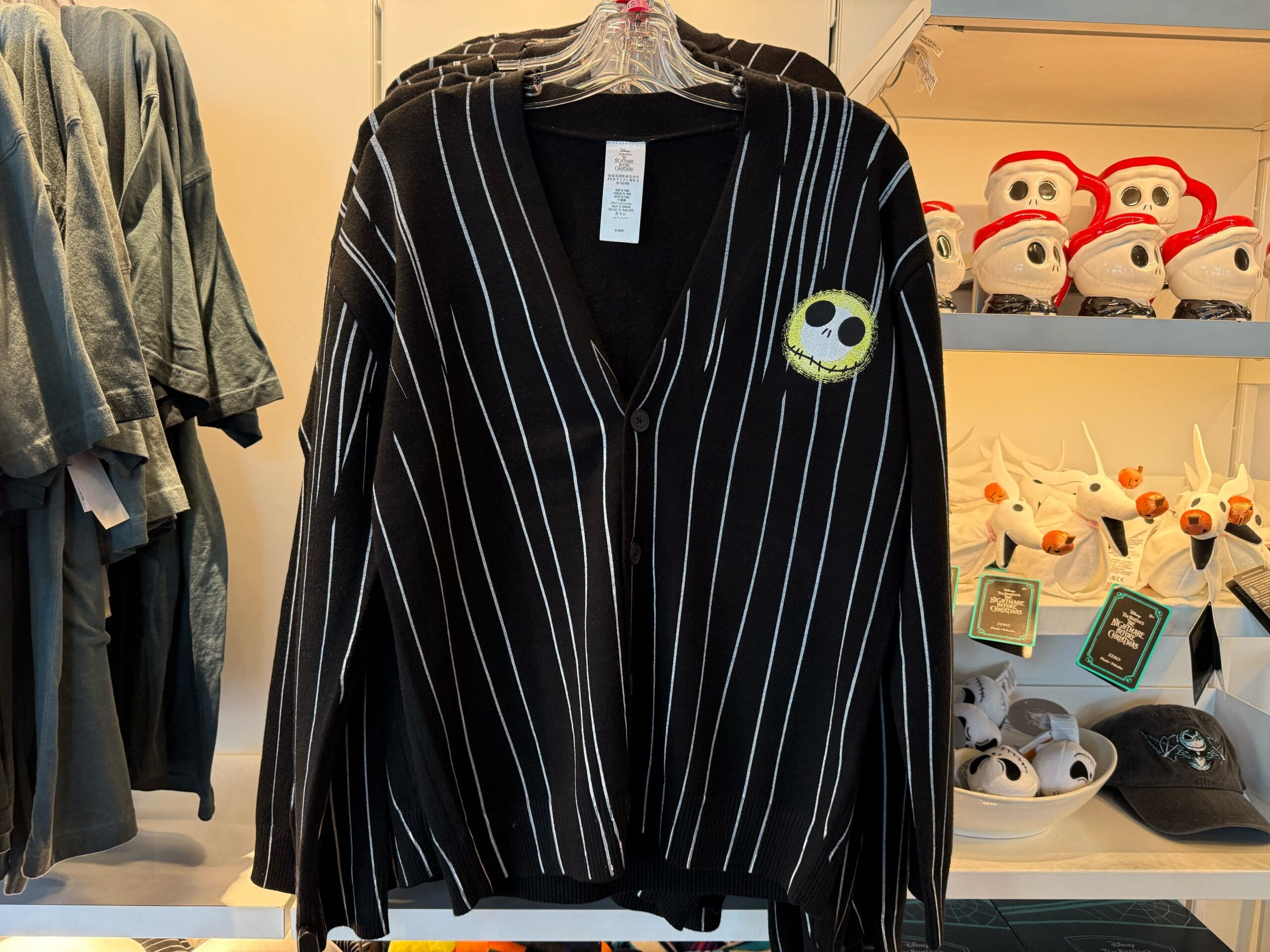 Black pinstripe cardigan with a yellow Jack Skellington patch—perfect Halloween merchandise spotted at Disneyland.