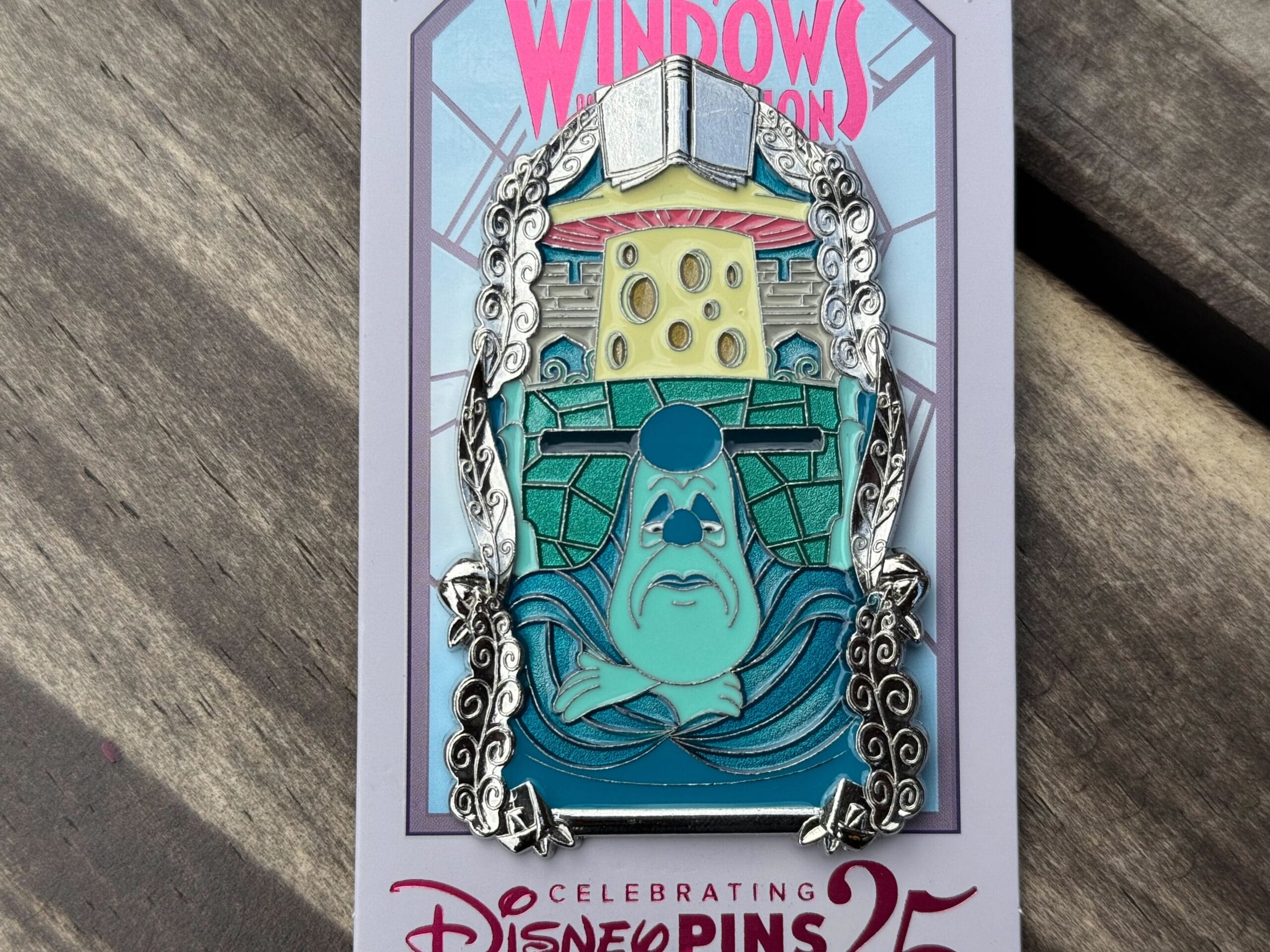 A colorful Monsters, Inc. pin featuring Roz with books and cheese, displayed on a special Disneyland pins anniversary card.