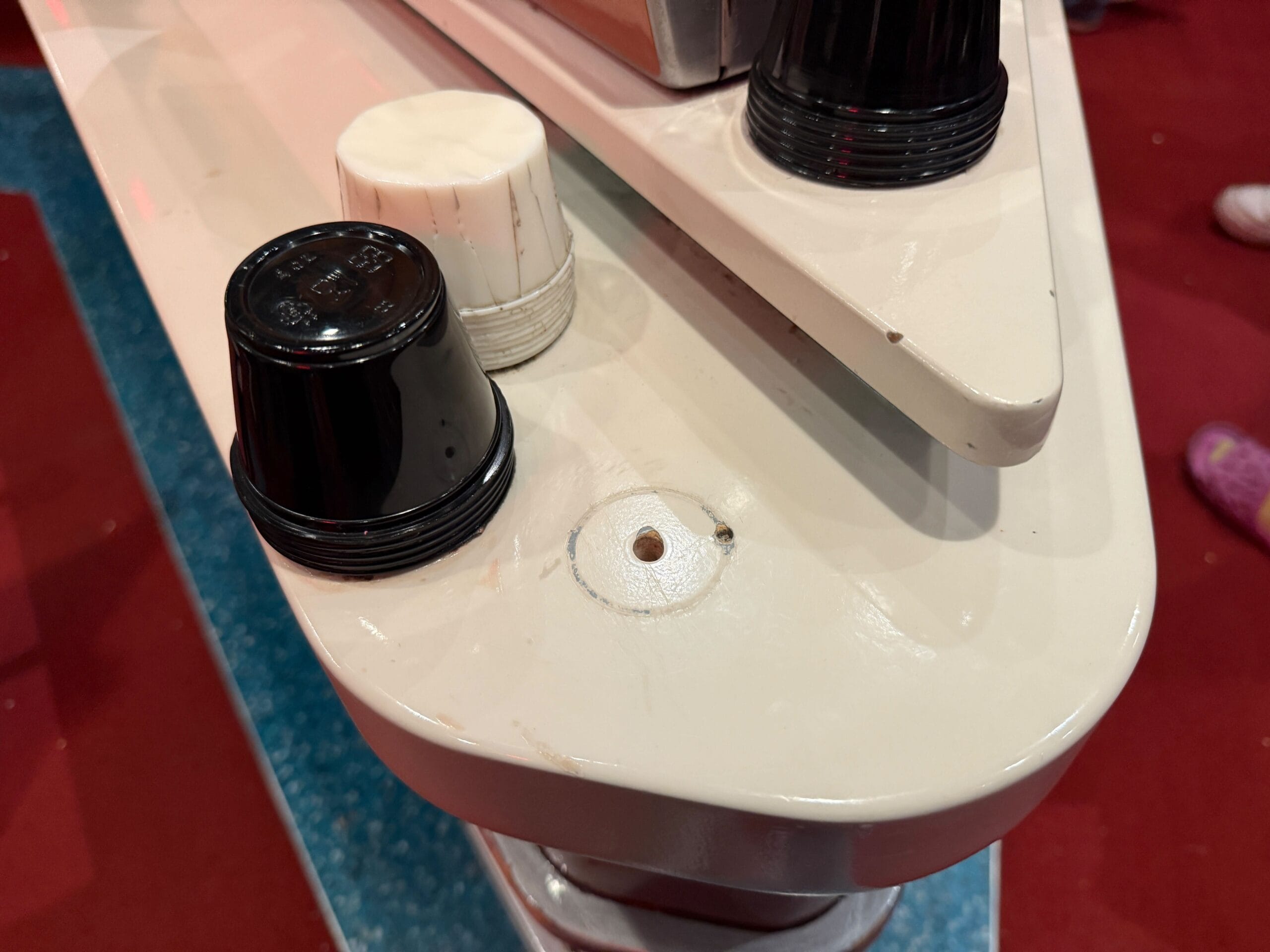 Close-up of coffee pods on a white countertop, inspired by Mickey & Minnie's Runaway Railway’s vibrant outdoor queue.