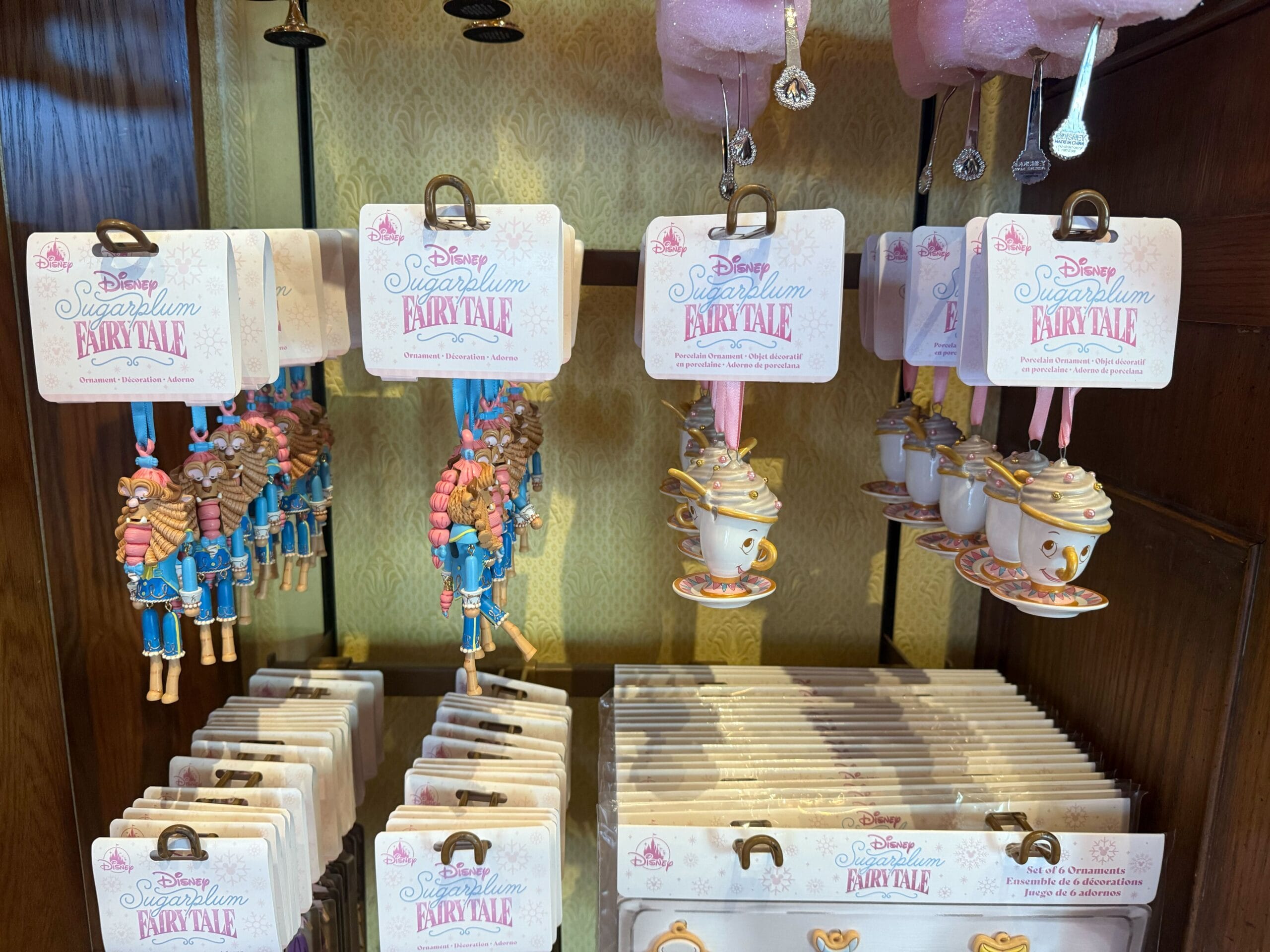 Ornaments shaped like nutcrackers and teacups hang on display, labeled "Disney Sugarplum Fairy Tale Collection.