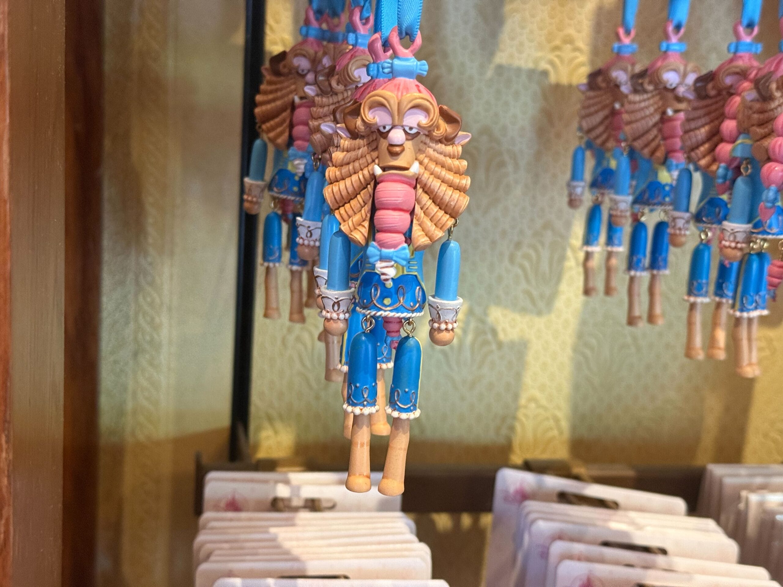 A Beast figurine ornament from "Beauty and the Beast" adds charm to any Ornament Collection, wearing a blue suit.