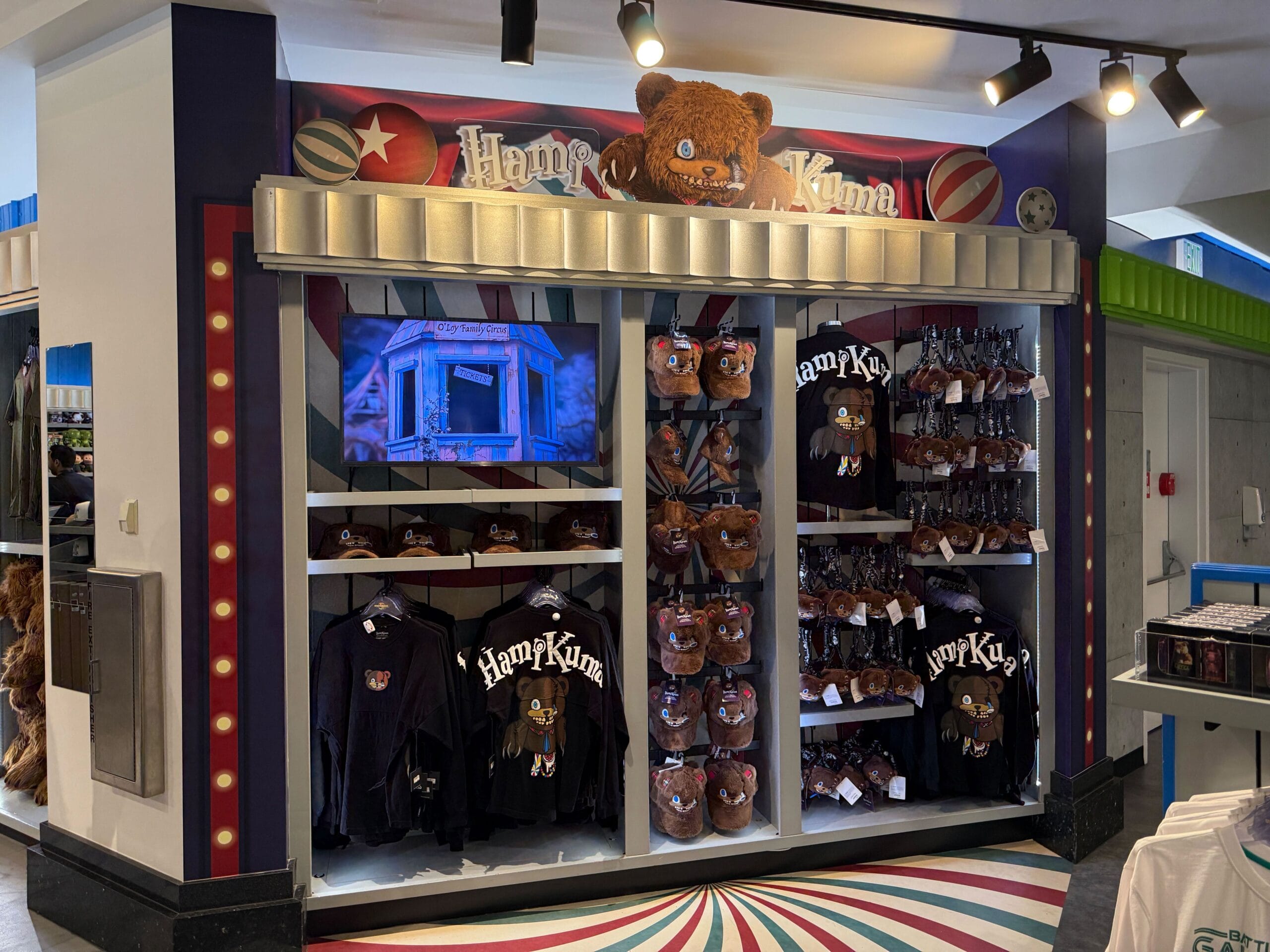Store display of HamiKuma Merchandise, with plush bear hats and black shirts, at Universal Orlando Resort.