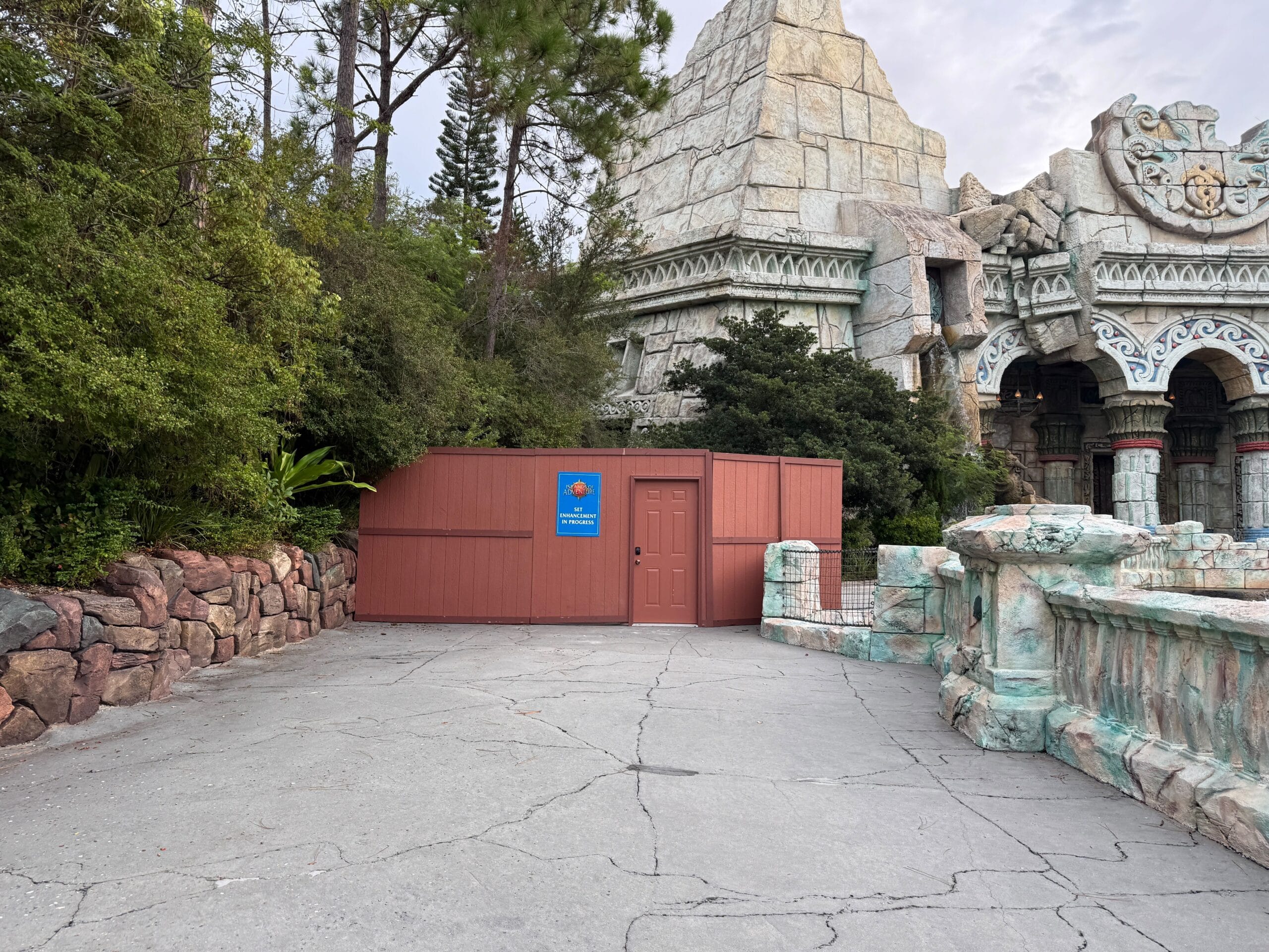 Construction walls block an area in front of a temple-like building in Islands of Adventure’s Lost Continent.