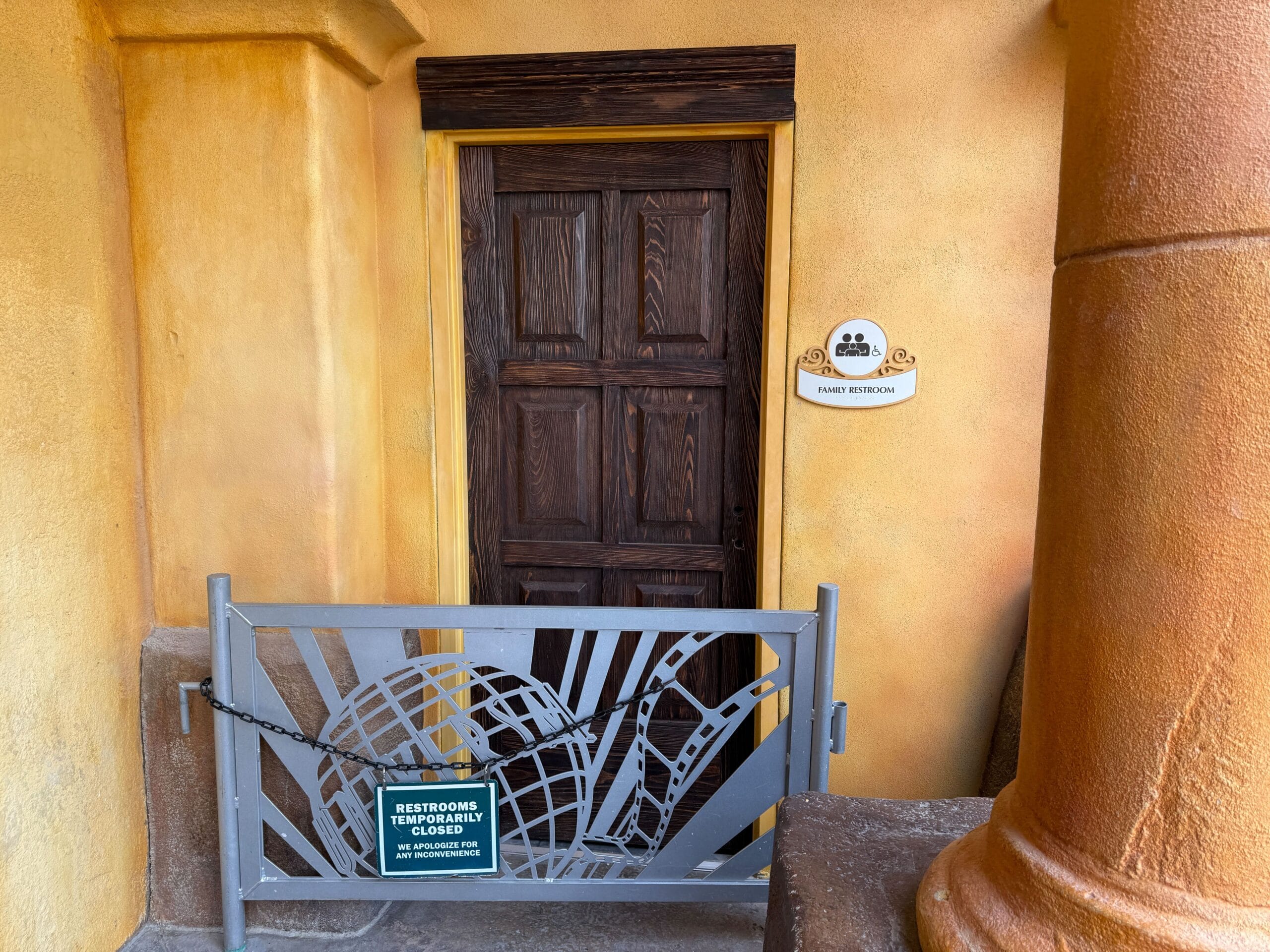 A closed Port of Entry Restrooms door at Universal Islands of Adventure, marked "Restrooms Temporarily Closed for Refurbishment.
