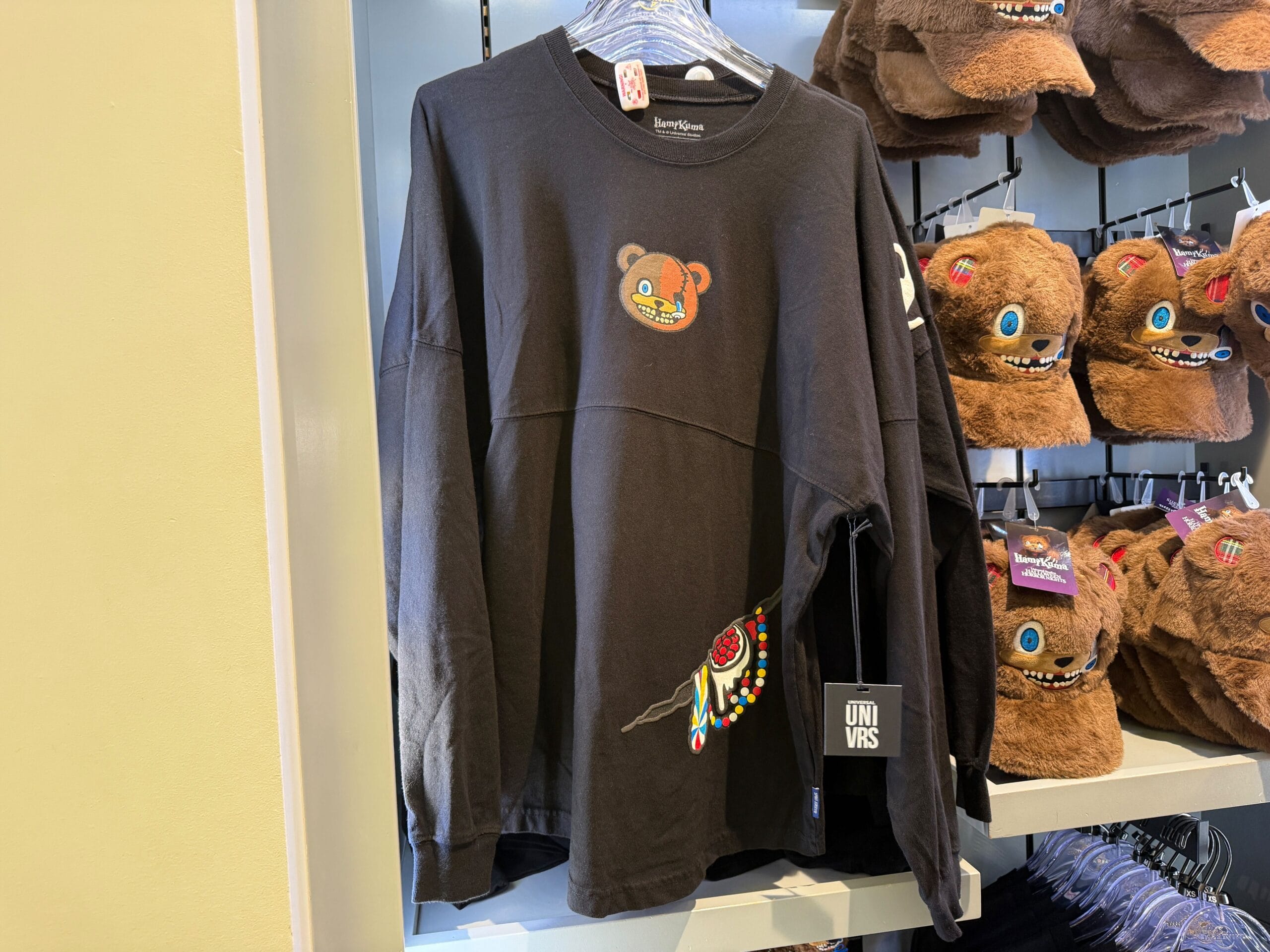 Black long-sleeve shirt with a bear face and HamiKuma Merchandise beadwork, spotted at Universal Orlando Resort.