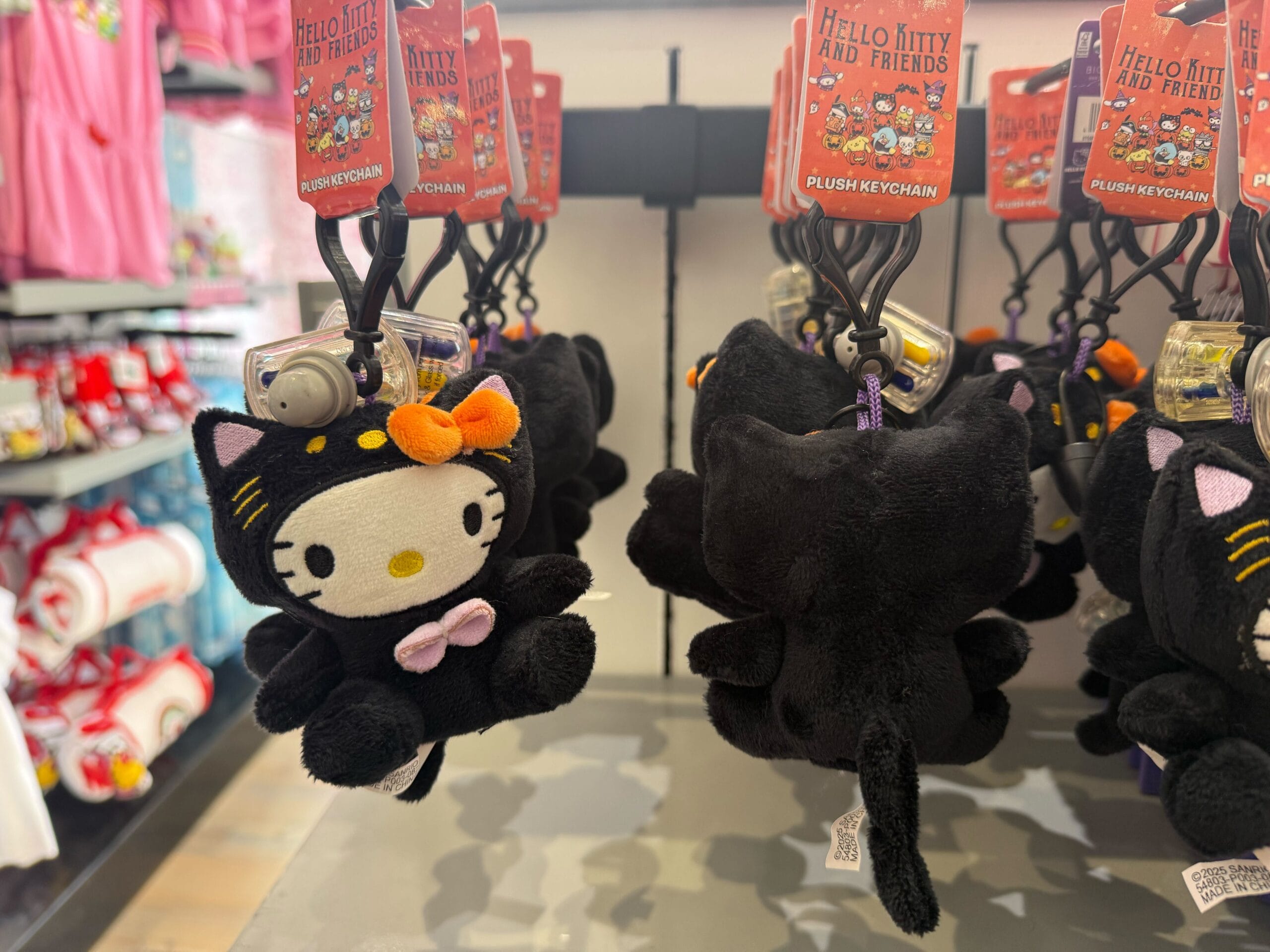 Plush Hello Kitty keychains in black cat costume—cute Halloween merchandise at Universal Studios Hollywood.