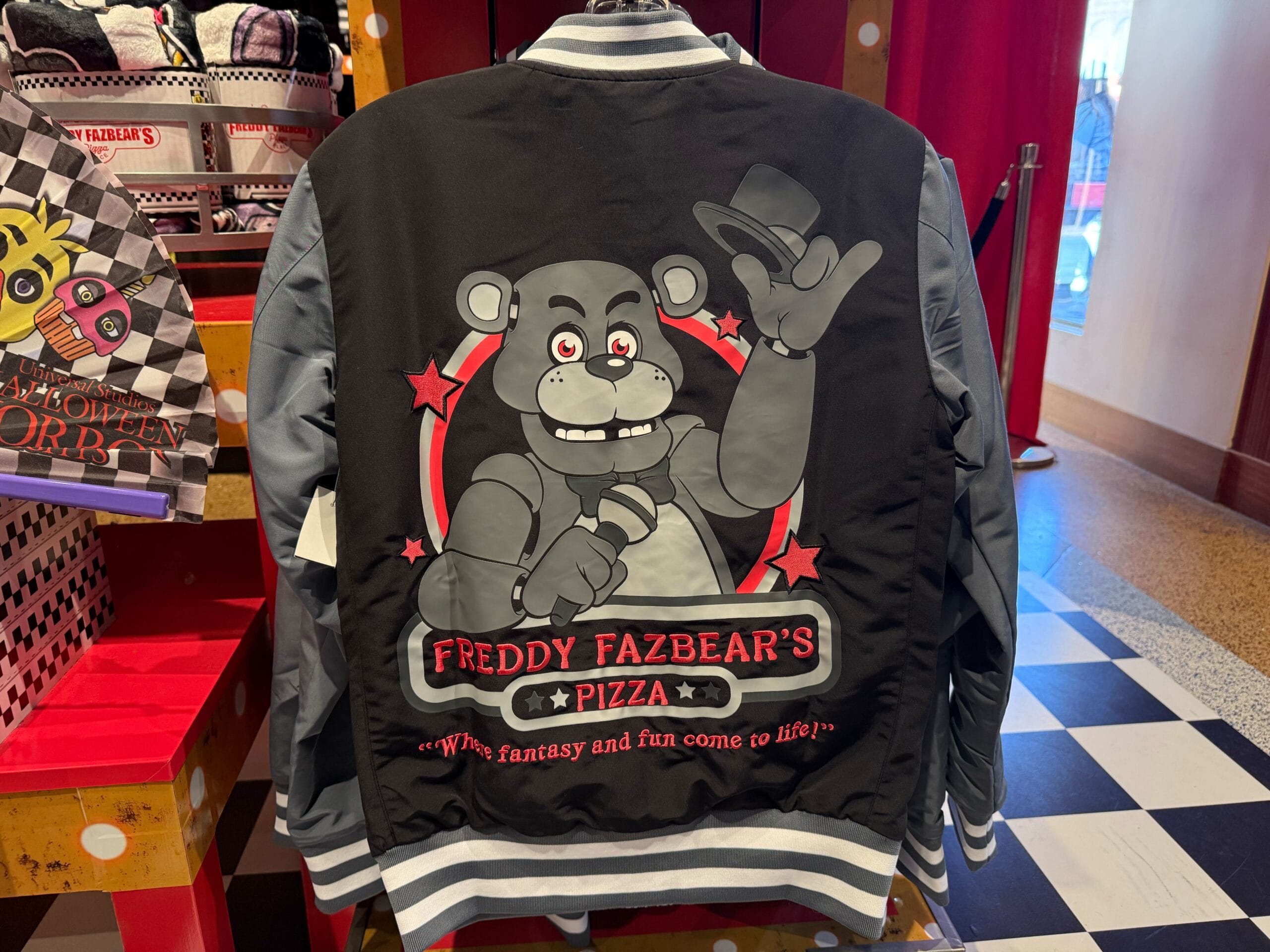 A varsity jacket featuring Freddy Fazbear and "Freddy Fazbear's Pizza" logo—perfect HHN Merch 2025 from Universal Studios Hollywood.