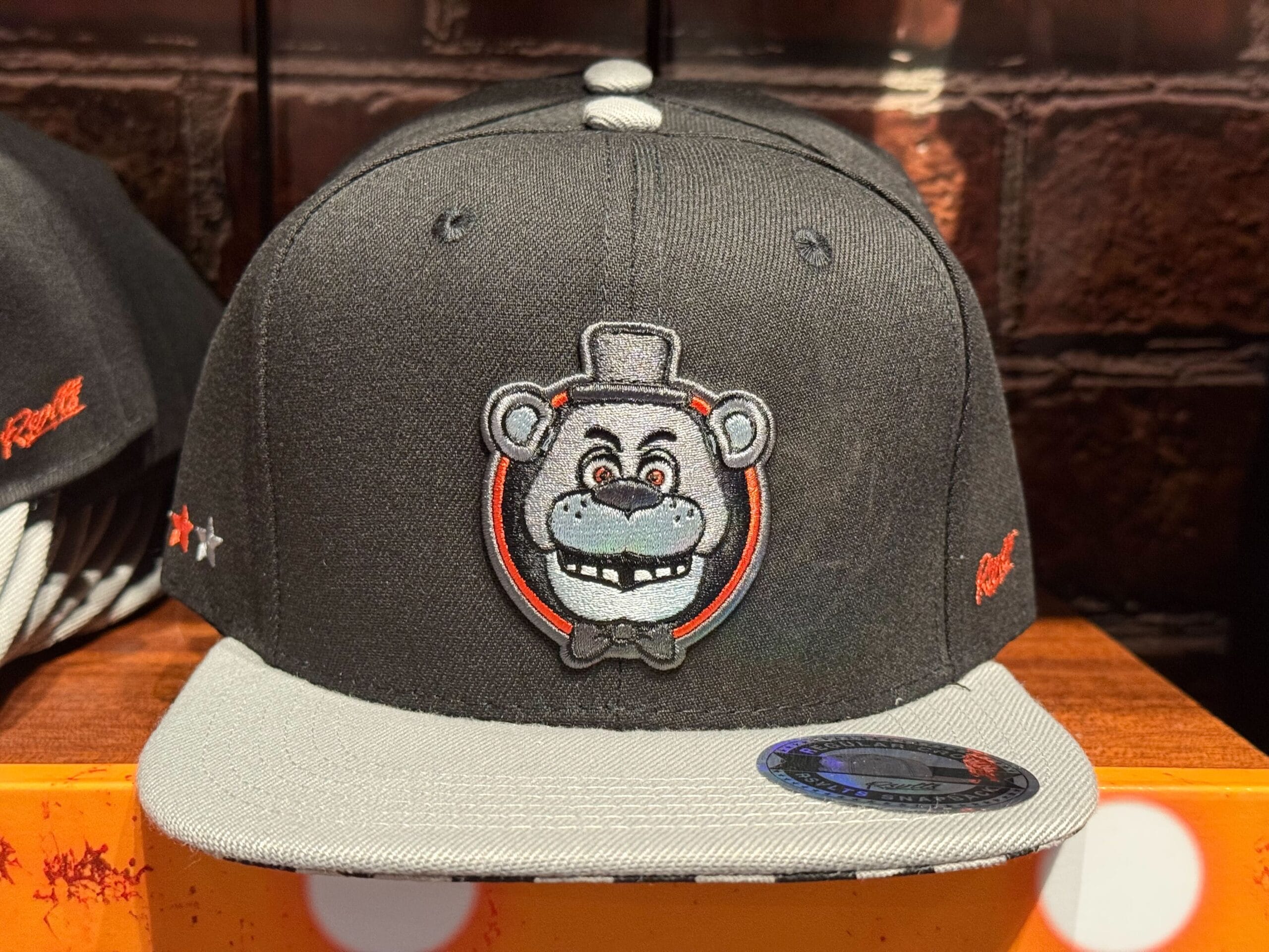 Black and gray cap featuring an embroidered bear face in a top hat—perfect HHN Merch 2025 for Universal Studios Hollywood.