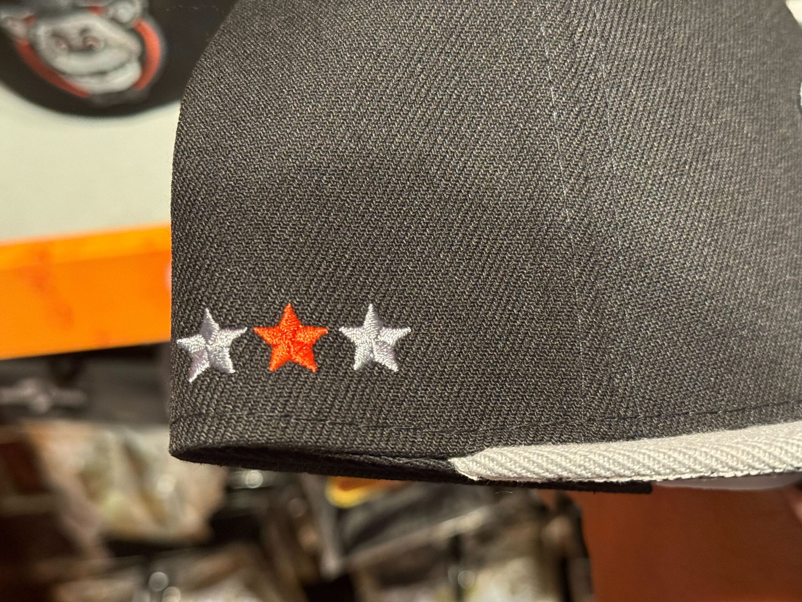 Black hat with three embroidered stars, part of the HHN Merch 2025 Halloween Horror Nights Merchandise collection.