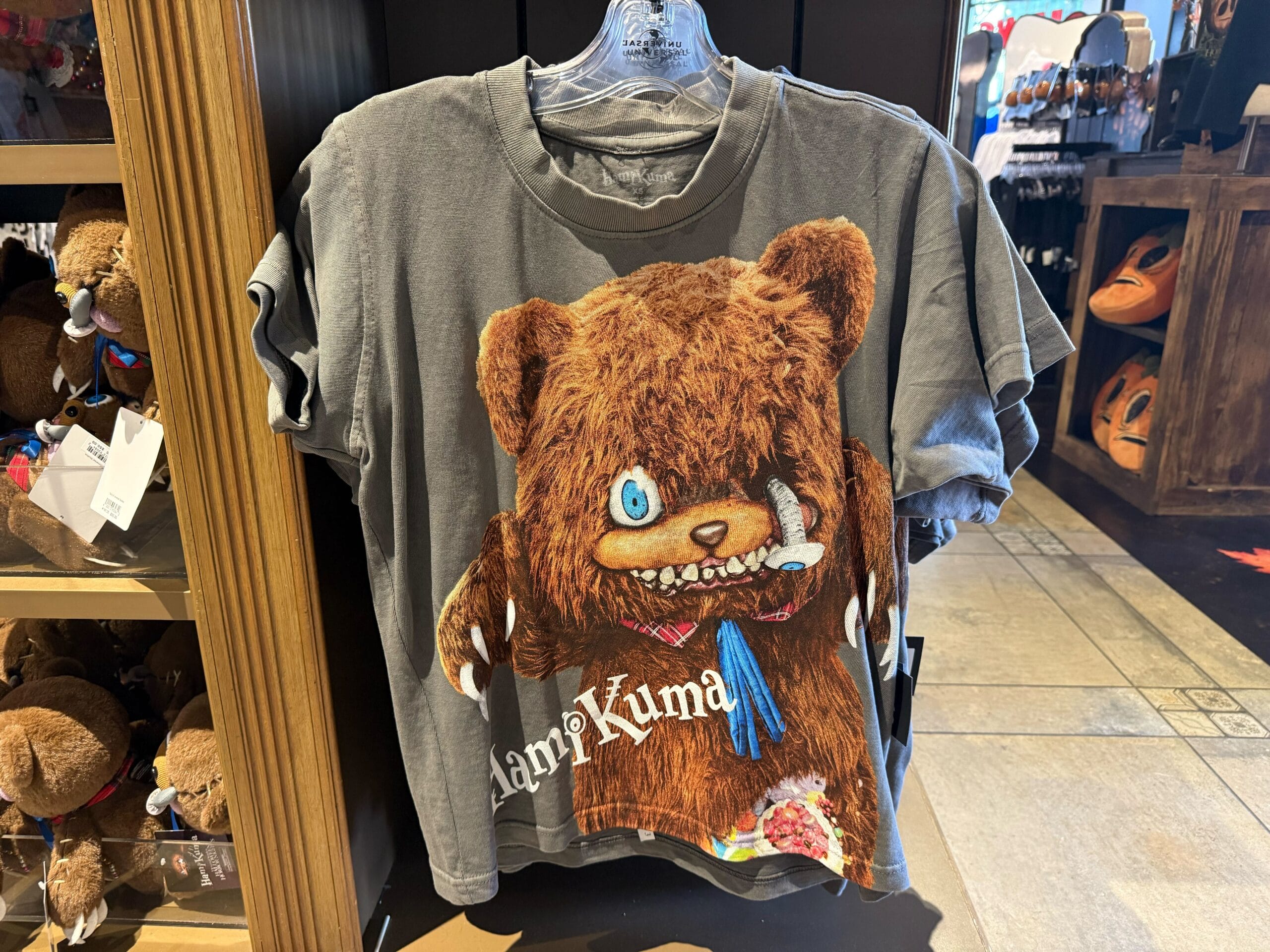 Gray T-shirt with a wild one-eyed bear graphic and "Kapi Kuma" text—perfect for Universal Studios Hollywood HHN Merch 2025.