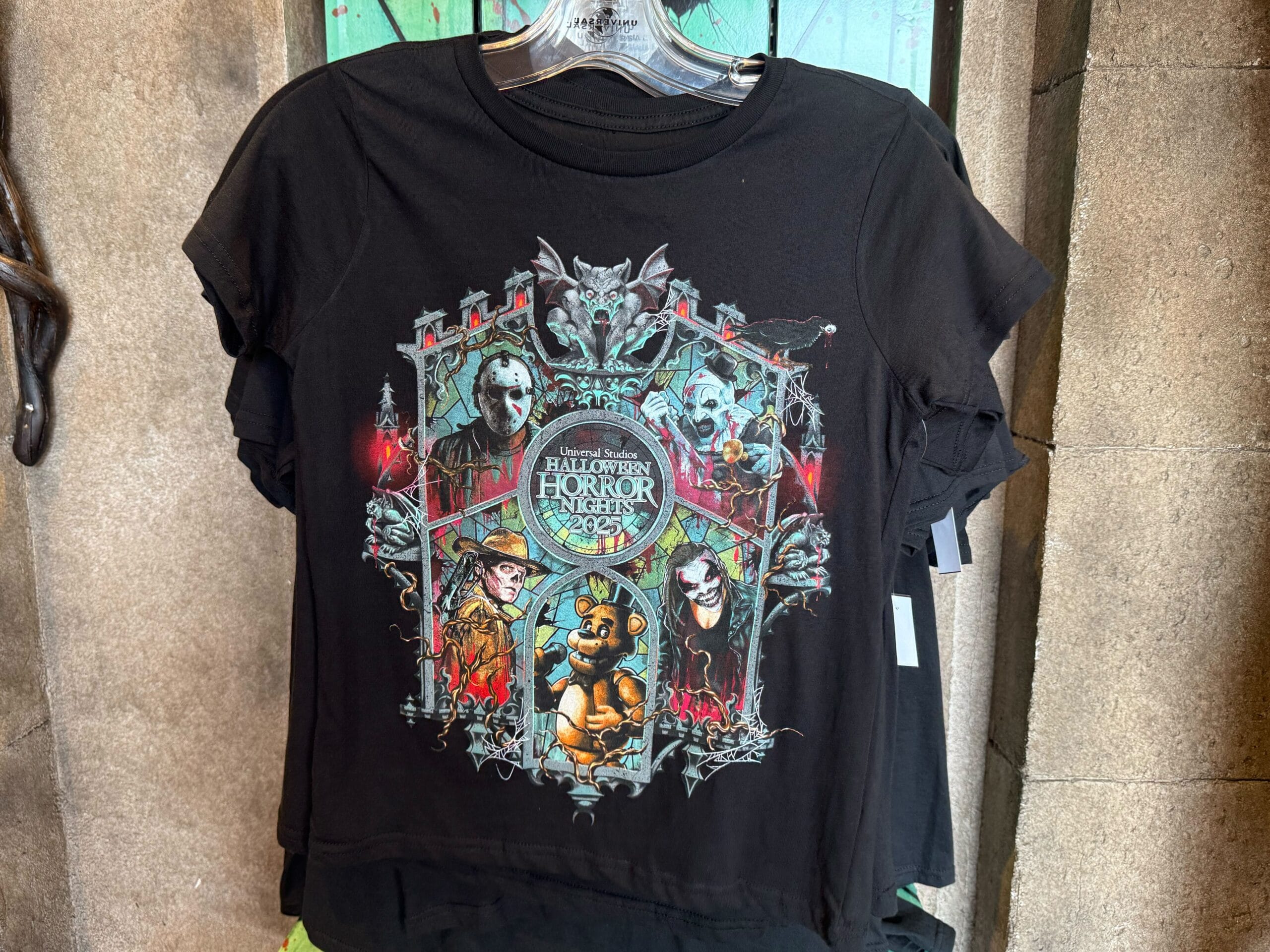 Black t-shirt with "Halloween Horror Nights 2023" graphic featuring spooky characters and gothic designs.