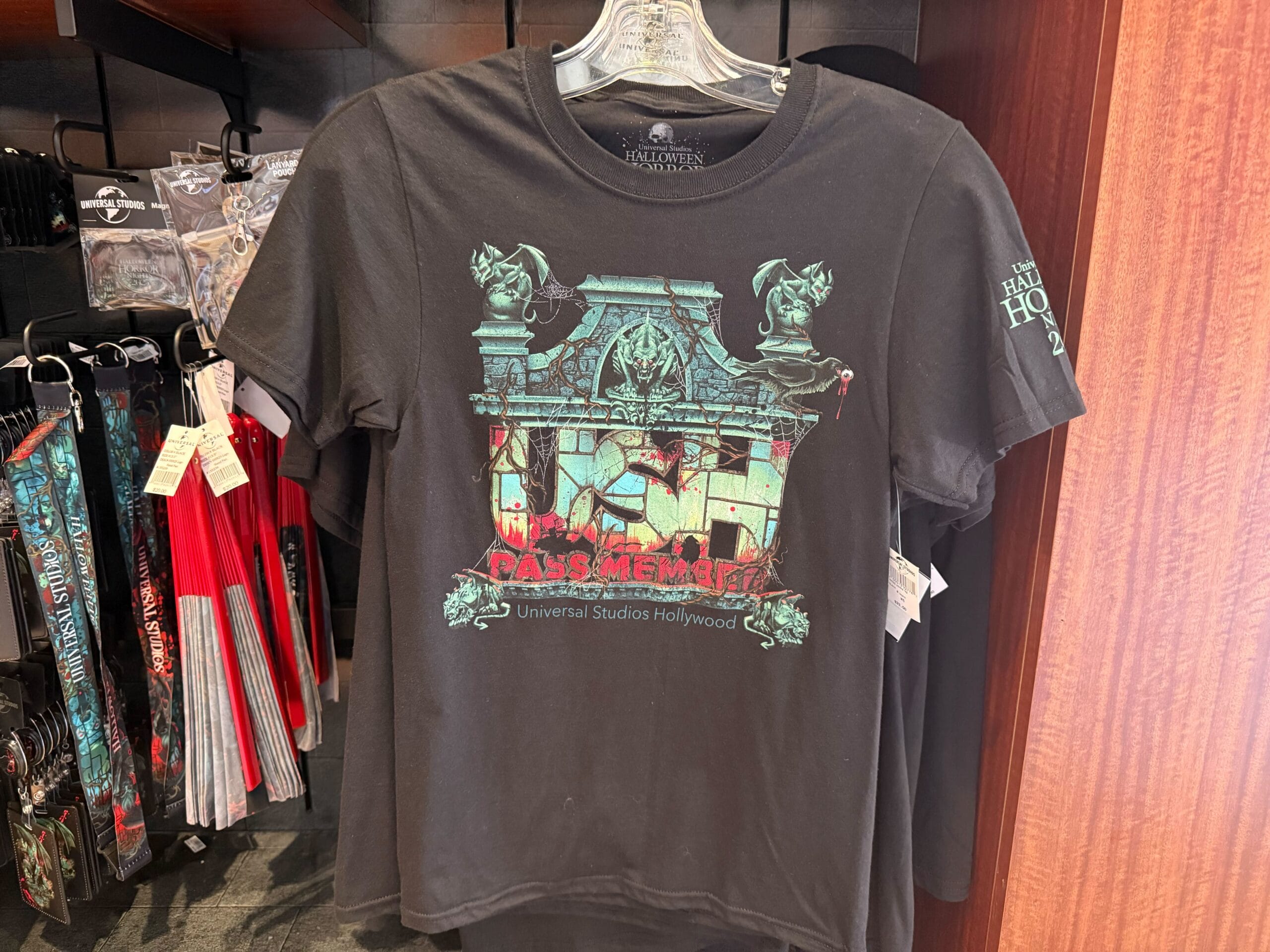 Black T-shirt with "PASS MEMBER" and haunted house graphic for Universal Studios Hollywood Halloween Horror Nights.