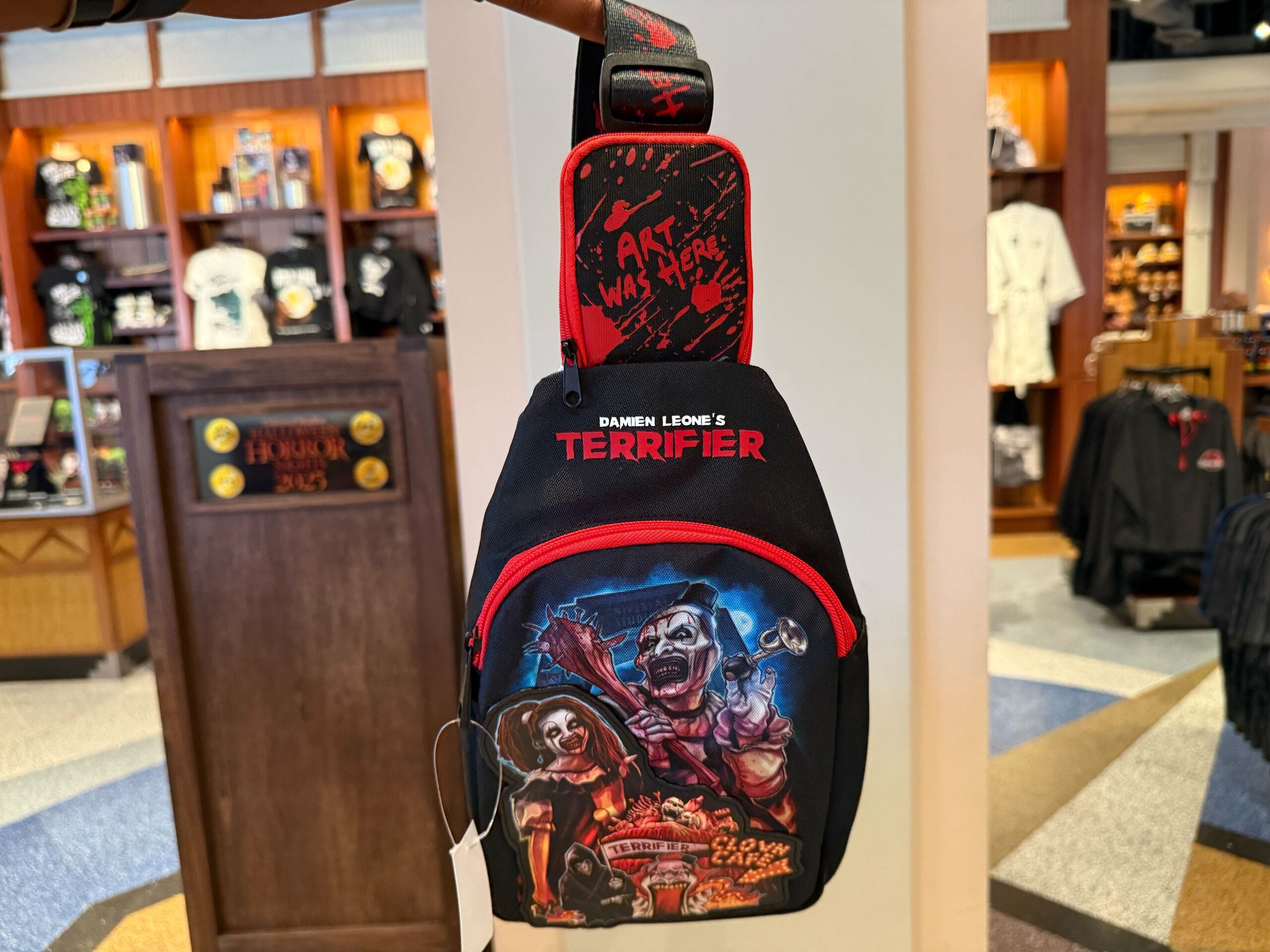 A black Terrifier-themed bag with horror artwork, perfect for Halloween Horror Nights Merchandise at Universal Studios Hollywood.